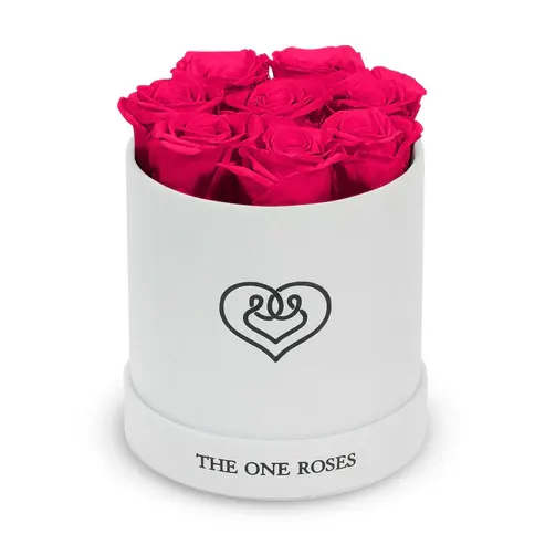 Suede Flat | Basic White hot pink Suede Flat | Basic White hot pink - Our White-Suede Basic Box with The One Eternity Roses comes in a luxury suede hand crafted box. About 8 stems of The One long lasting (med size) preserved real roses.  Durability: approx. 1-3 years.  Product Dimension: 6″ × 6″ / 8 ROSES  Our roses, which are carefully sourced from the highest quality gardens in Ecuador, are made to represent the eternal yet ephemeral nature of Love itself. Our Roses are specially customized with essential oils to increase the fragrance.  Product Care: DO NOT Water the roses! AVOID direct exposure to sunlight. Keep the arrangement in a room-temperature environment. If dust collects after a few months, remove it lightly using a duster. DO NOT place anything onto the roses as they can crush and damage the roses. DO NOT remove the roses from the box; they are secure and happy there. DO NOT allow roses to have direct contact with light colored fabric or surfaces, as staining may occur. The lid is meant to stay on the side or bottom of the box. Be mindful when carrying the arrangement: it's a very delicate product!
