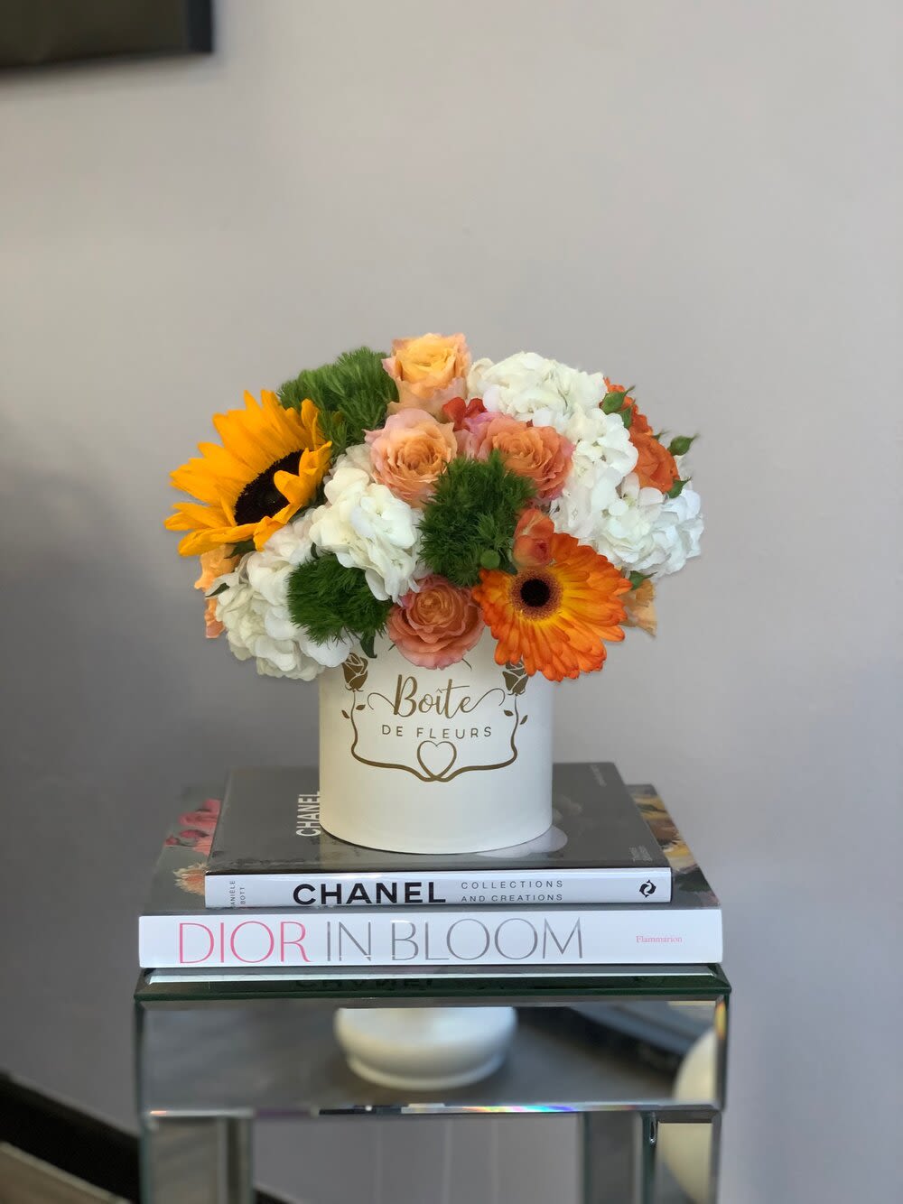 Southern Belle Boîte(Black Box) - Free spirit roses, hydrangea, sunflowers, and accent flowers nestle in an ivory boîte box. A perfect way to brighten up your loved one’s day.