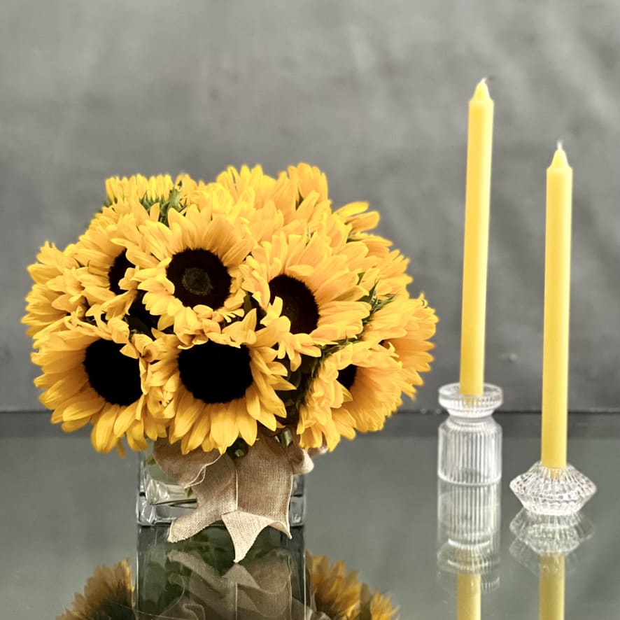 My Sunshine My Sunshine - This sunny design of sunflowers is set in a 5 X 5 glass vase 8" Round , tied with a beautiful bow. Sure to put a smile on anyone's face. Deluxe: 6" Glass Cube 10" Round Premium 8" Glass Cube 12" Round
