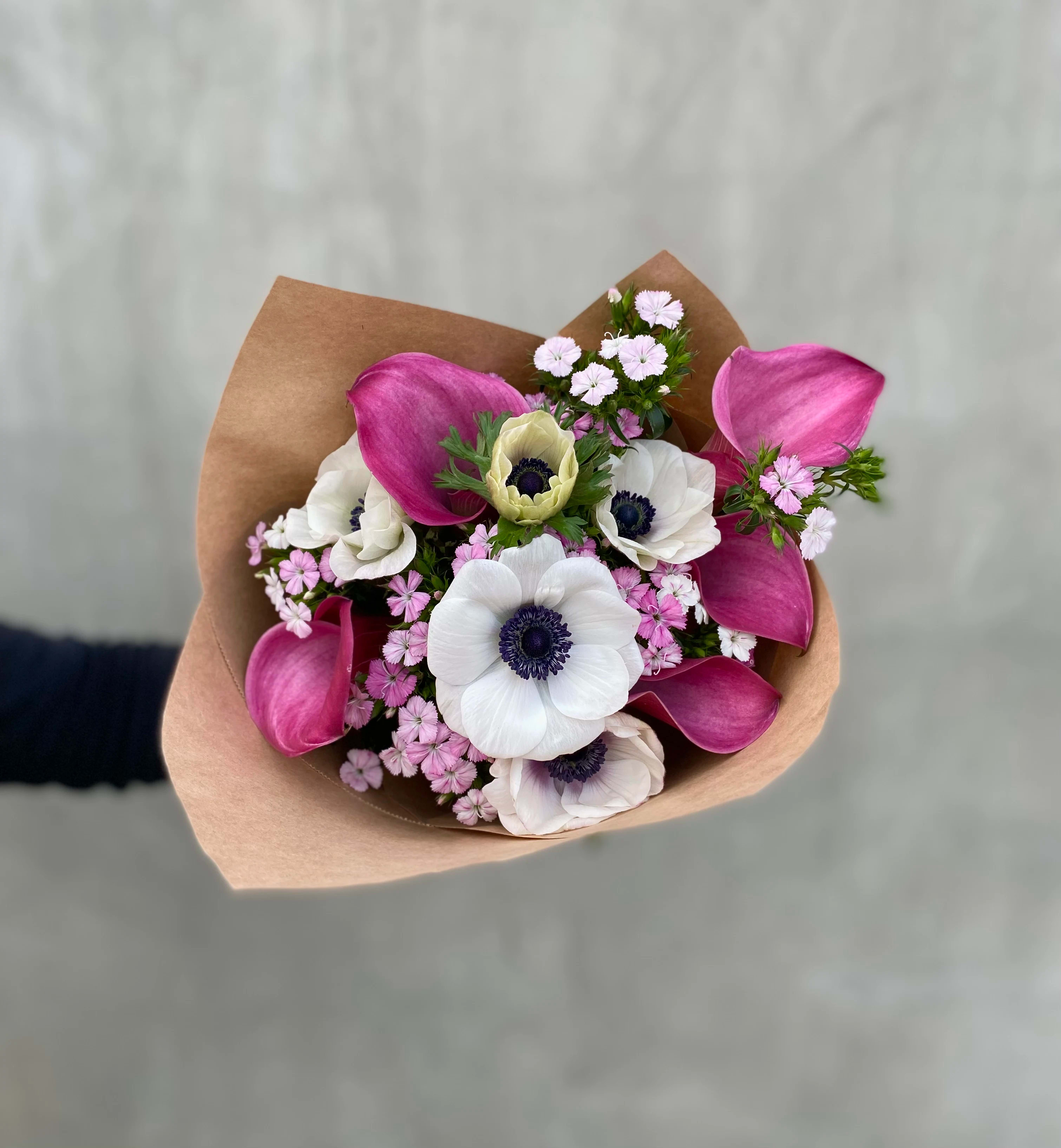Poppies &amp; Calla Lillies - This bouquet includes anemone and calla lilies wrapped in brown paper. The picture shown above is a standard.