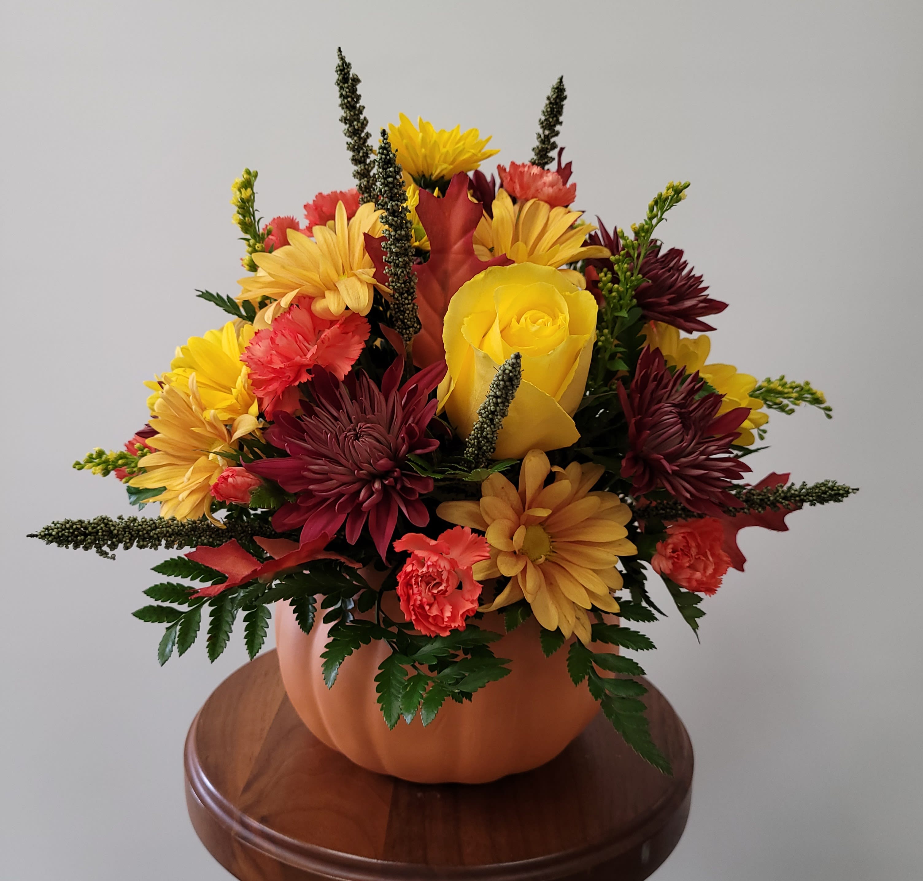 Pretty Pumpkin Pretty Pumpkin - Bring autumn in with this seasonal arrangement housed in a "pretty pumpkin!" You will surely “fall” in love with this collection of fall flowers. Flowers may vary due to seasonal availability. Due to product availability, substitutions on the container may be necessary.