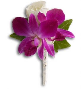 Fresh in Fuchsia Boutonniere Fresh in Fuchsia Boutonniere - An exotic orchid meets its match in a radiant white rose. Purple dendrobium orchids with white roses and ivy. Approximately 3 1/2" W x 4 3/4" H Orientation: N/A