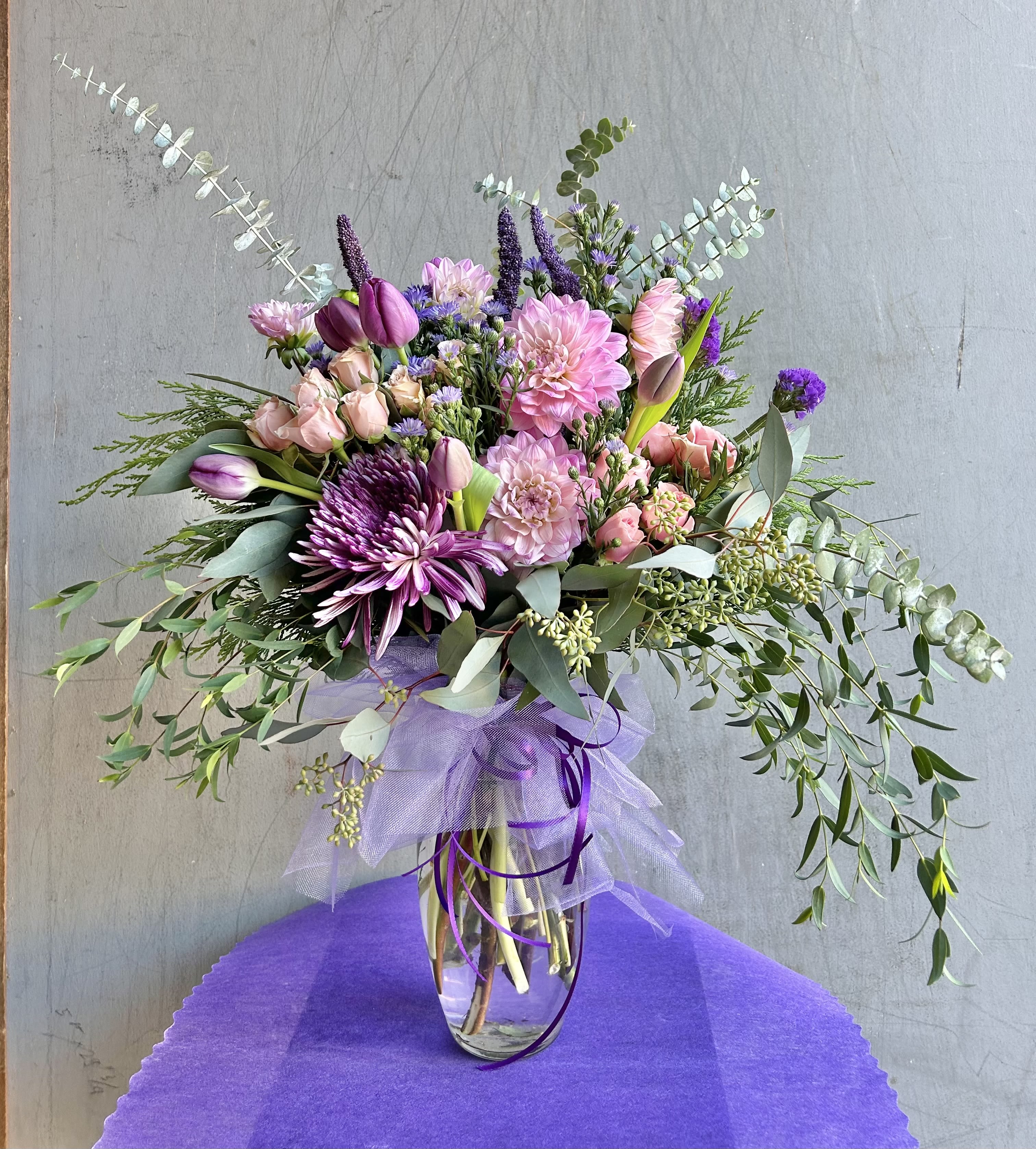 Timeless Blooms - Beautiful pink and purple arrangement featuring tulips, chrysanthemums, spray roses, and green accents.