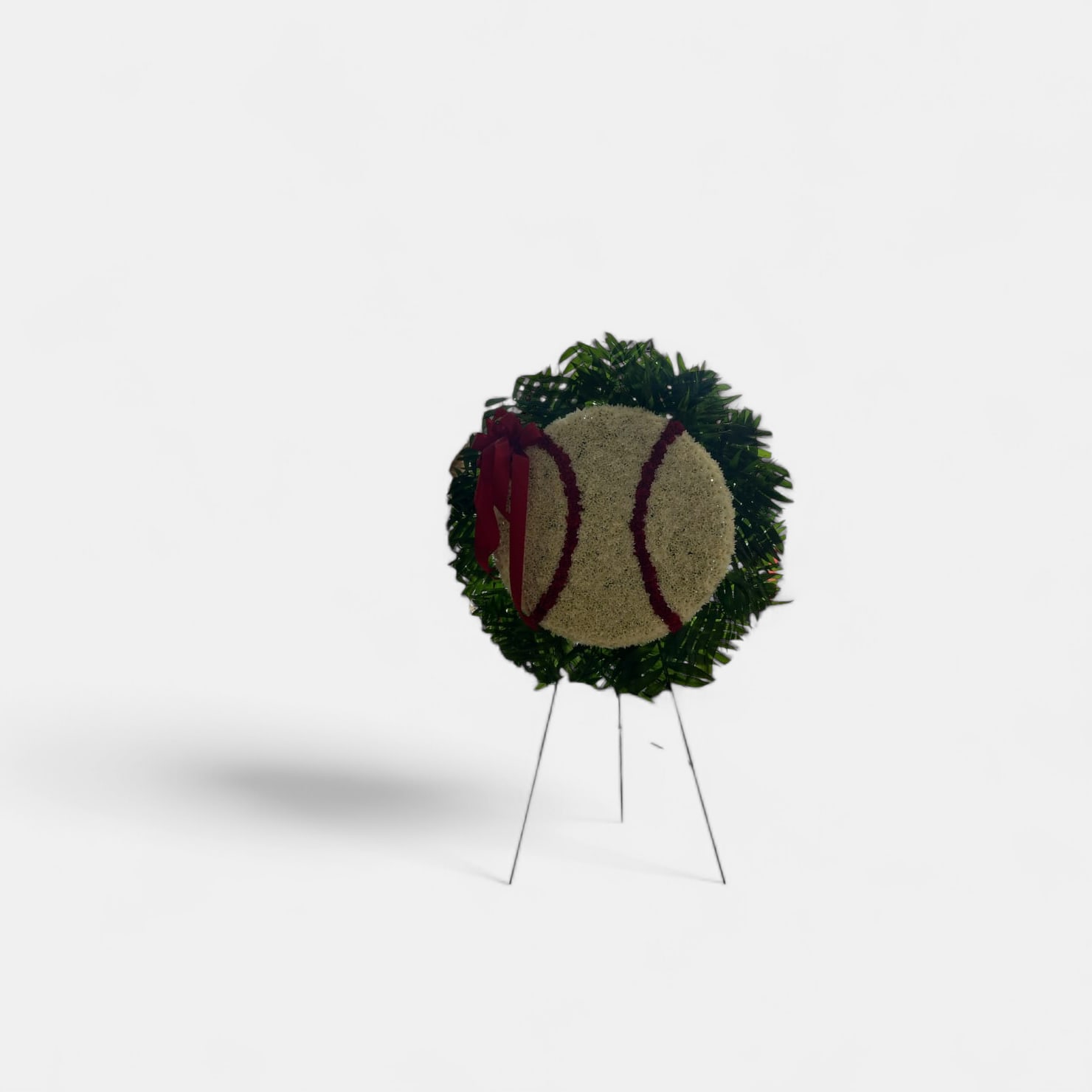 BASEBALL STANDING SPRAY - Description: A large baseball  made of carnations and cushion spray mums the perfect tribute for a loved one.   Easel and shamrock total height and width is about  66&quot; tall, 30&quot; wide.   Custom pieces take about 5 hours to create. In order to create beautiful pieces like this, please allow at least 24 hrs. for order.