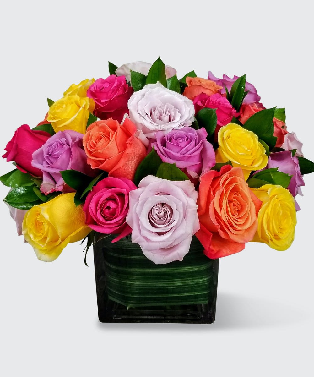 Rose Jubalee Rose Jubalee - Beautiful multicolored Roses arranged in a clear glass cube vase.
