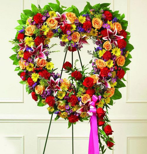 Assorted Colors Hollow Heart - Assorted colors Hollow Heart made with Carnations, Roses, Lilies, Carnations and fillers.