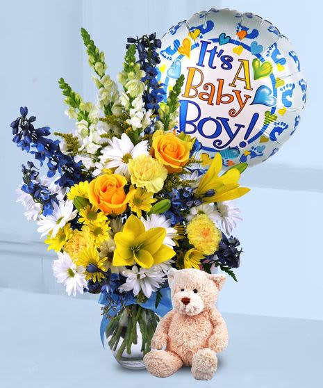 He has Arrived! Bouquet He has Arrived! Bouquet - Welcome the new addition with this beautiful bouquet of blues, yellows and whites et in a clea vase with a mylar balloon and plush bear.