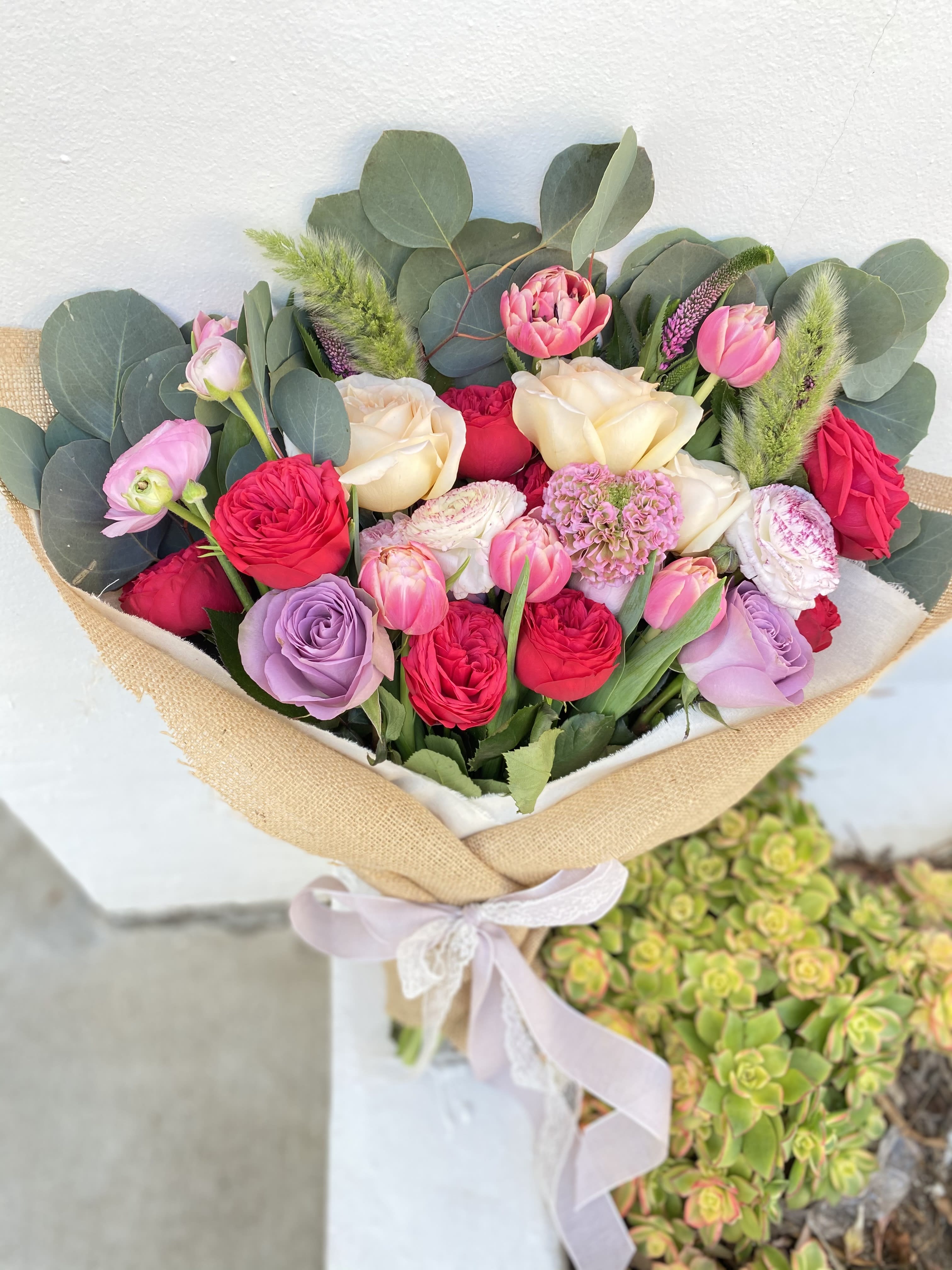 Adore You Adore You - A beautiful and fun mixture of spring flowers wrapped in burlap and ivory fabric.
