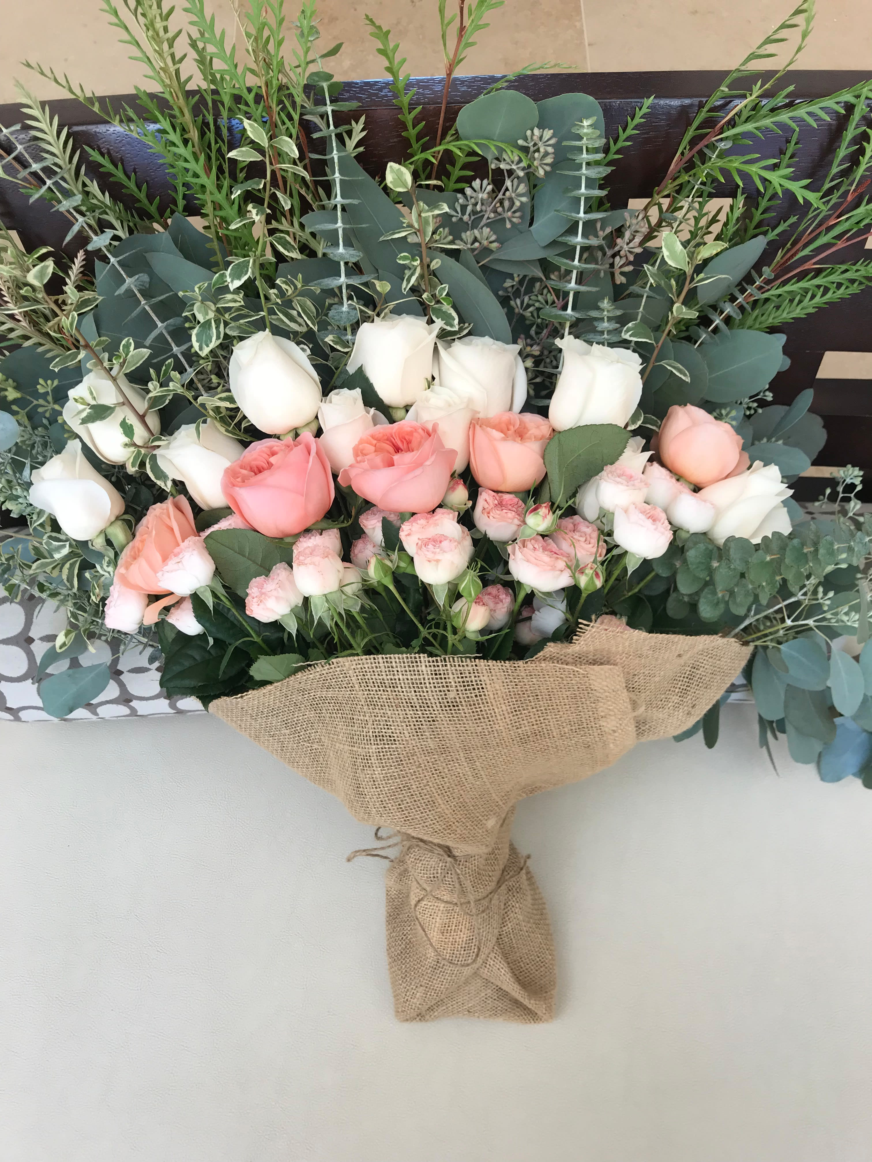 Cute Blooms Cute Blooms - An assortment of roses, natures greenery wrapped in burlap with ribbon.