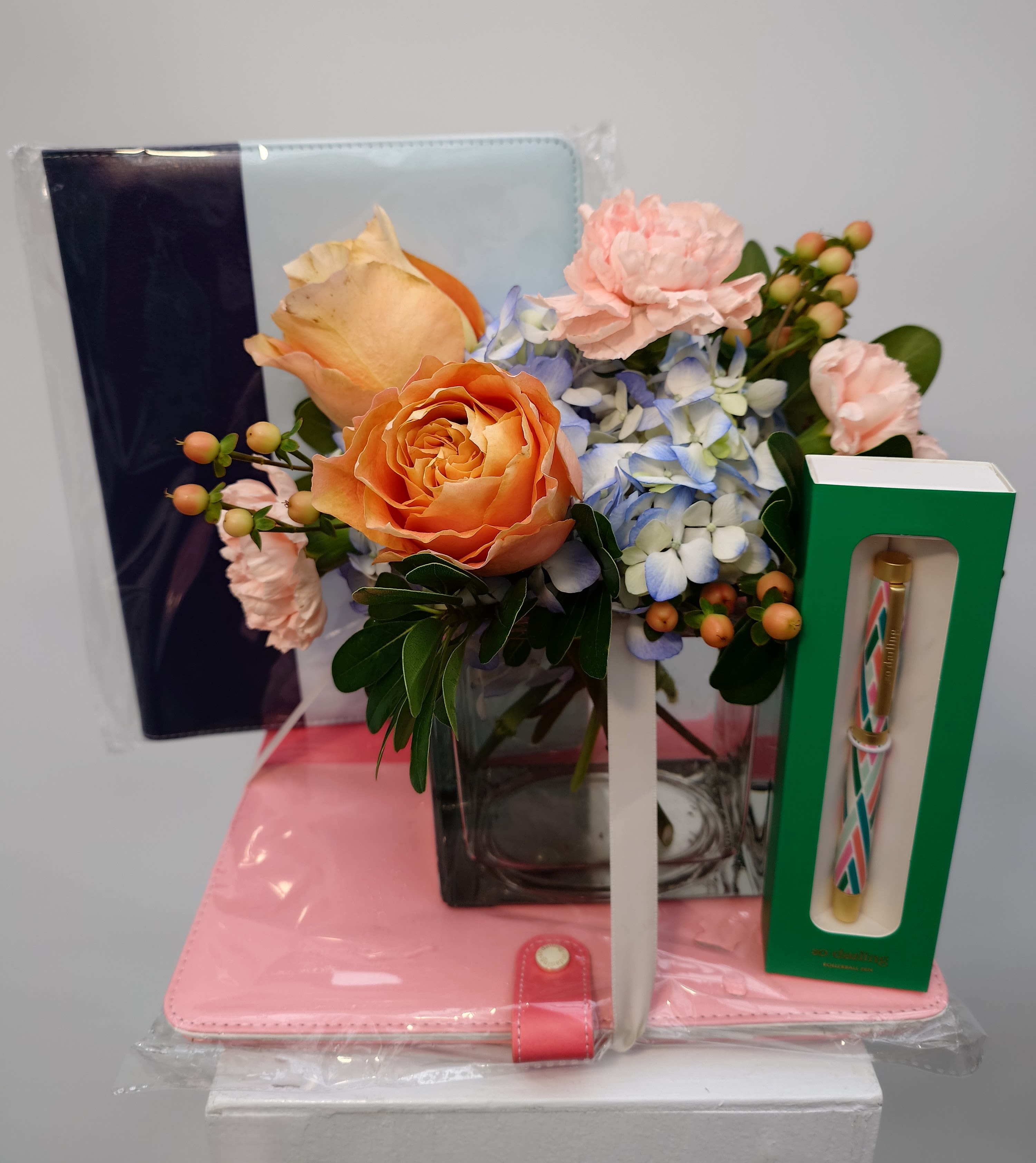The Scholar - Send your scholar some inspiration with this luxe vegan-leather-bound notebook in peach or light blue accompanied by a fine ballpoint pen -- plus a cheerful floral arrangement to brighten their day. We do same-day delivery to Cornell, Ithaca College and Tompkins Community College.