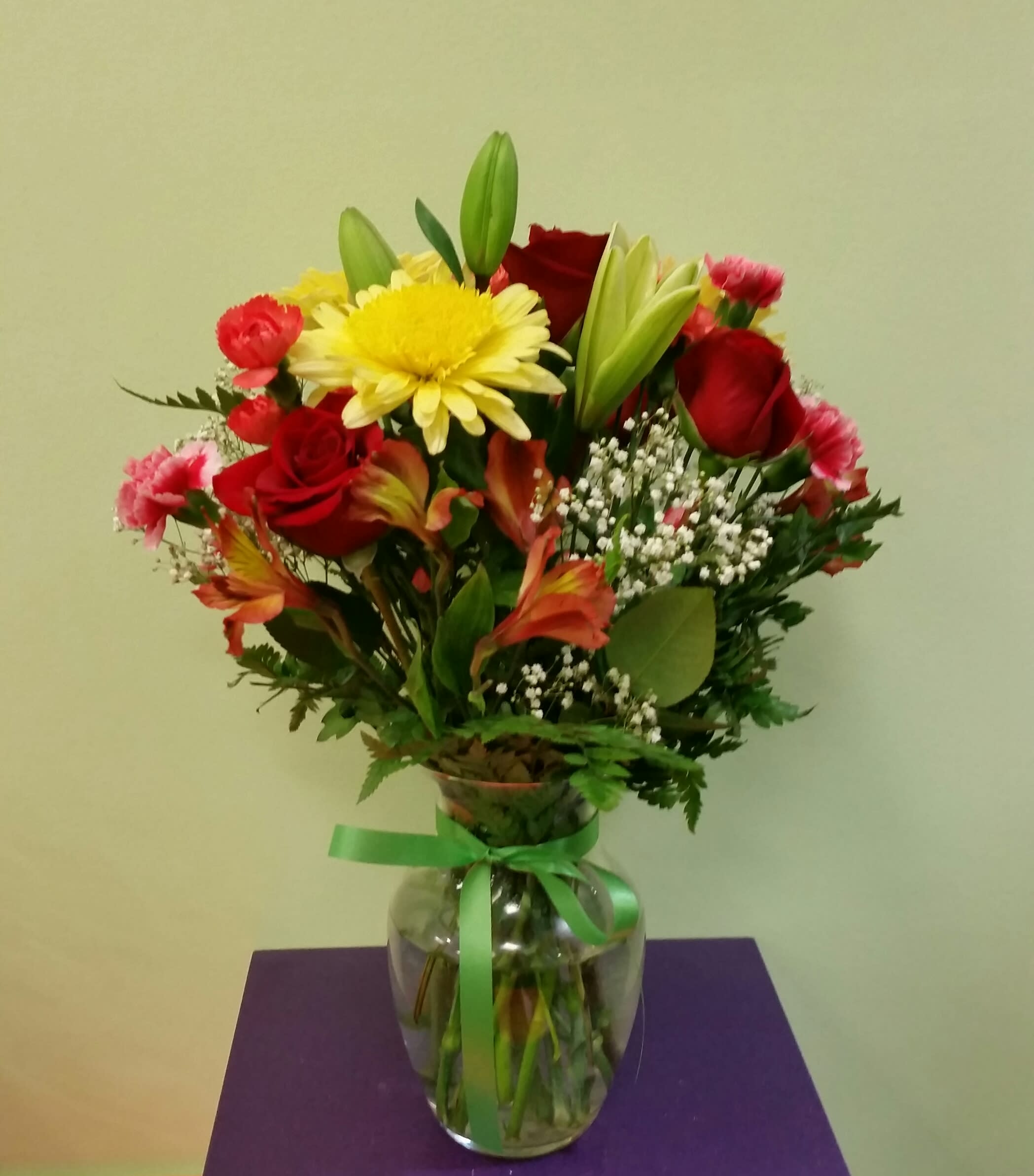 Summer Breeze - This summery mix of bright and cheery flowers will shine like the fun. With fiery red roses and golden mums, this arrangement will melt their heart. 