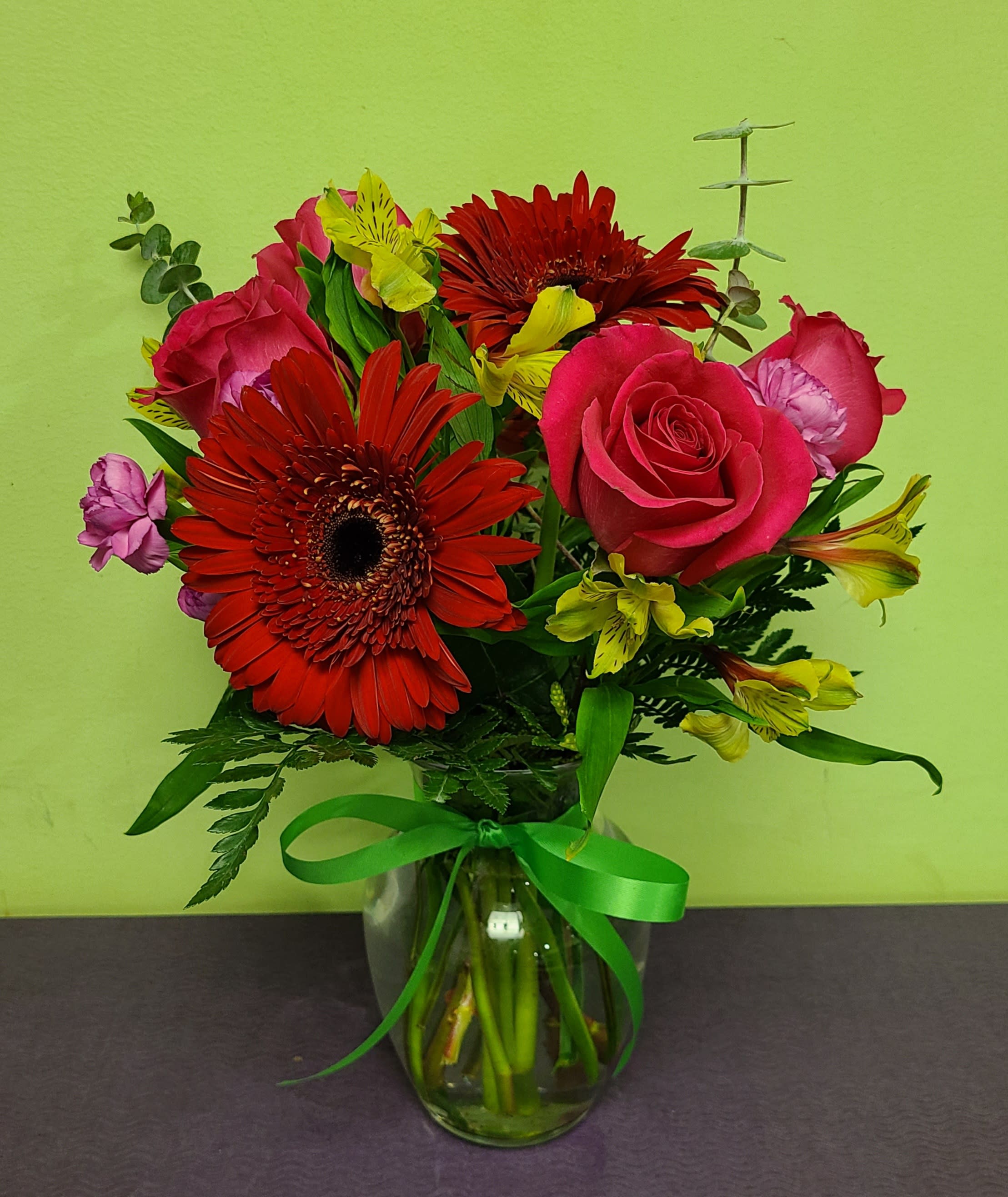The Watermelon - This refreshing is perfect for a hot Summer day, or any day for that matter. With its bright red Gerbera Daisies and hot pink Roses, it will certainly warm their hearts. This arrangement also includes long lasting Carnations and Alstromeria. 