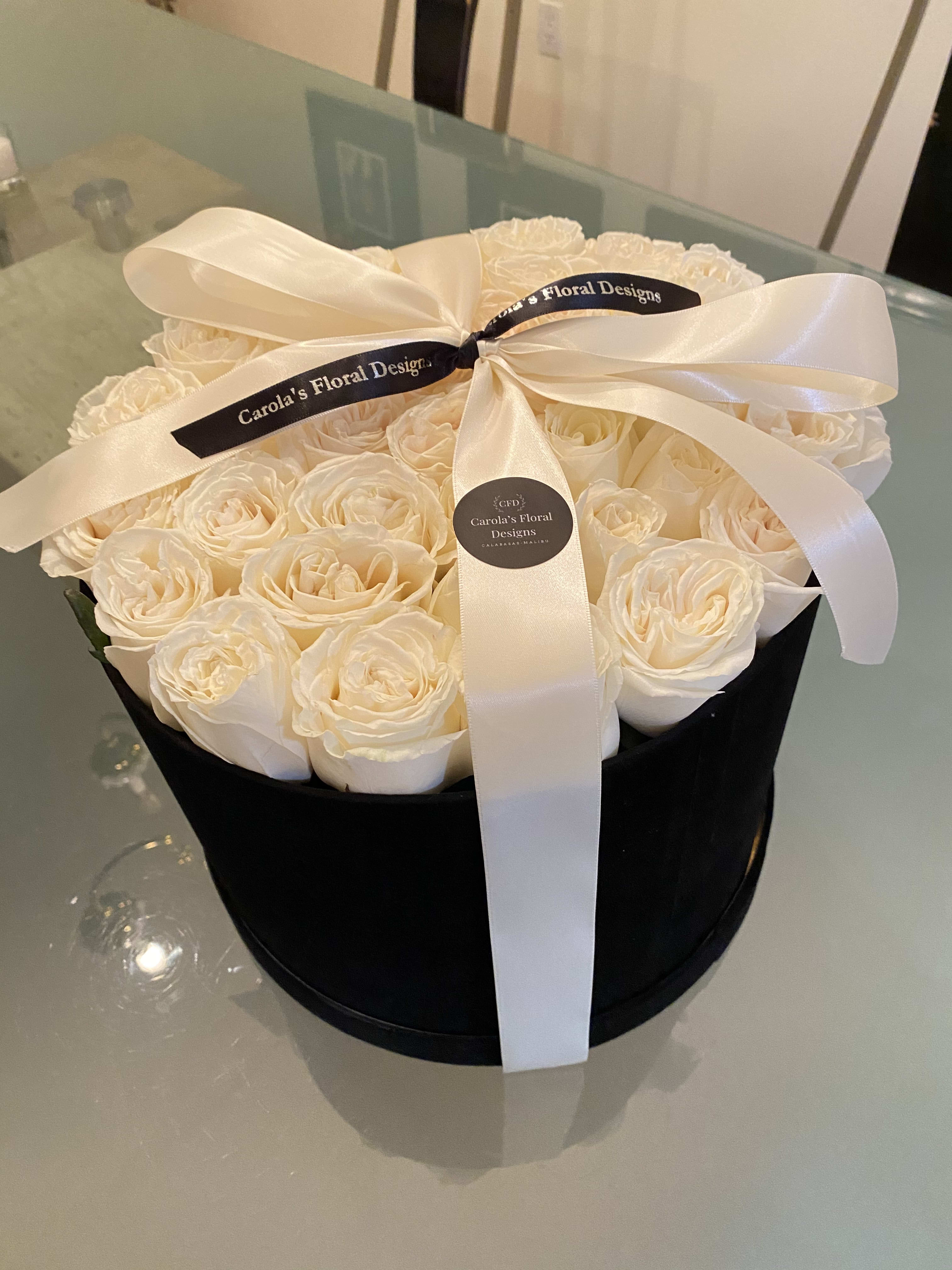 Midnight in Paris - The delicate white roses displayed inside a beautiful black velvet box with a touch of a doubled sided satin ribbon to tight together the perfect gift.  
