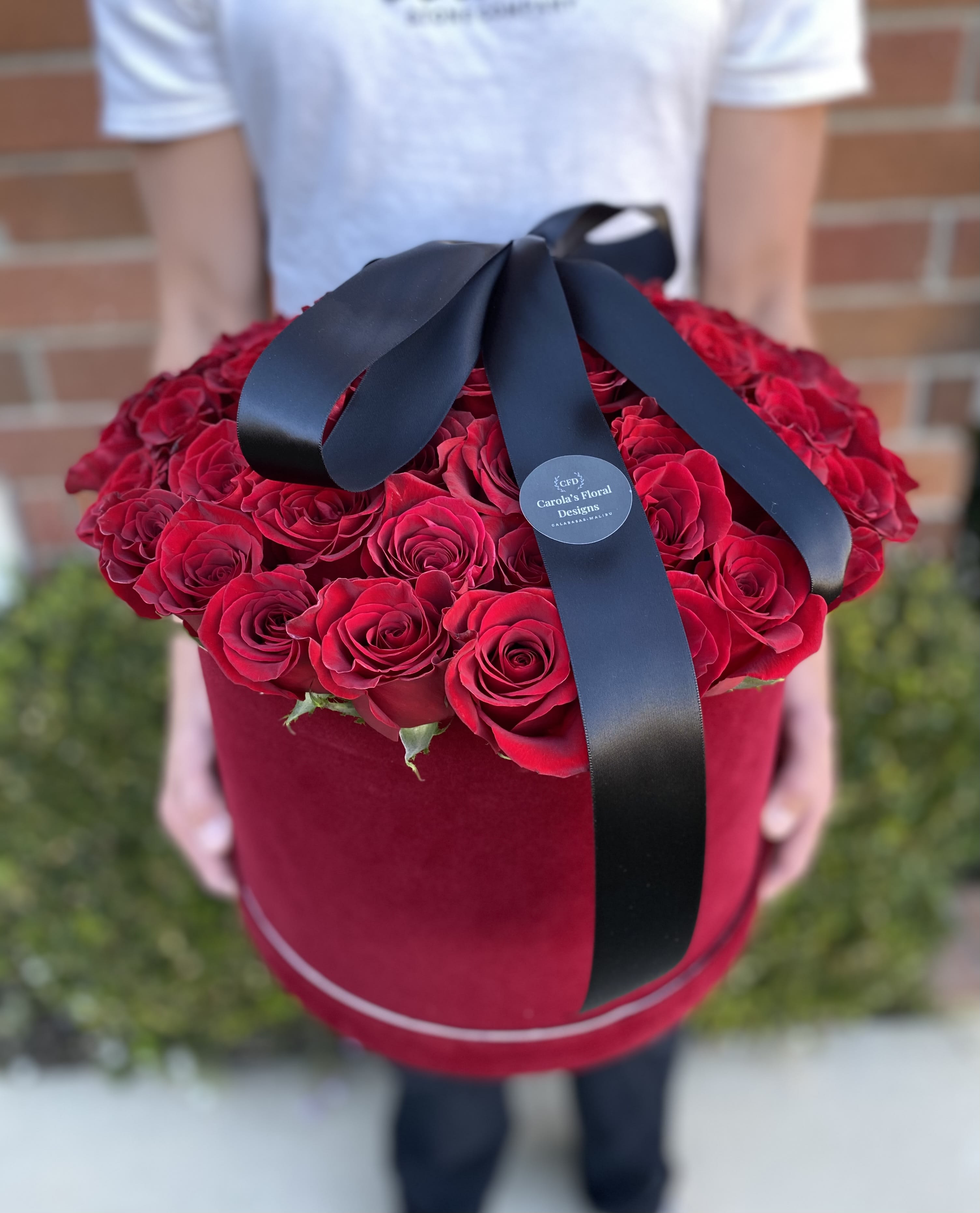 Red Velvet Box Red Velvet Box - Enjoy the elegance of this romantic red velvet box and the deep red roses carefully displayed inside the box. Doubled sided black ribbon gives the perfect touch to impressed you loved one.