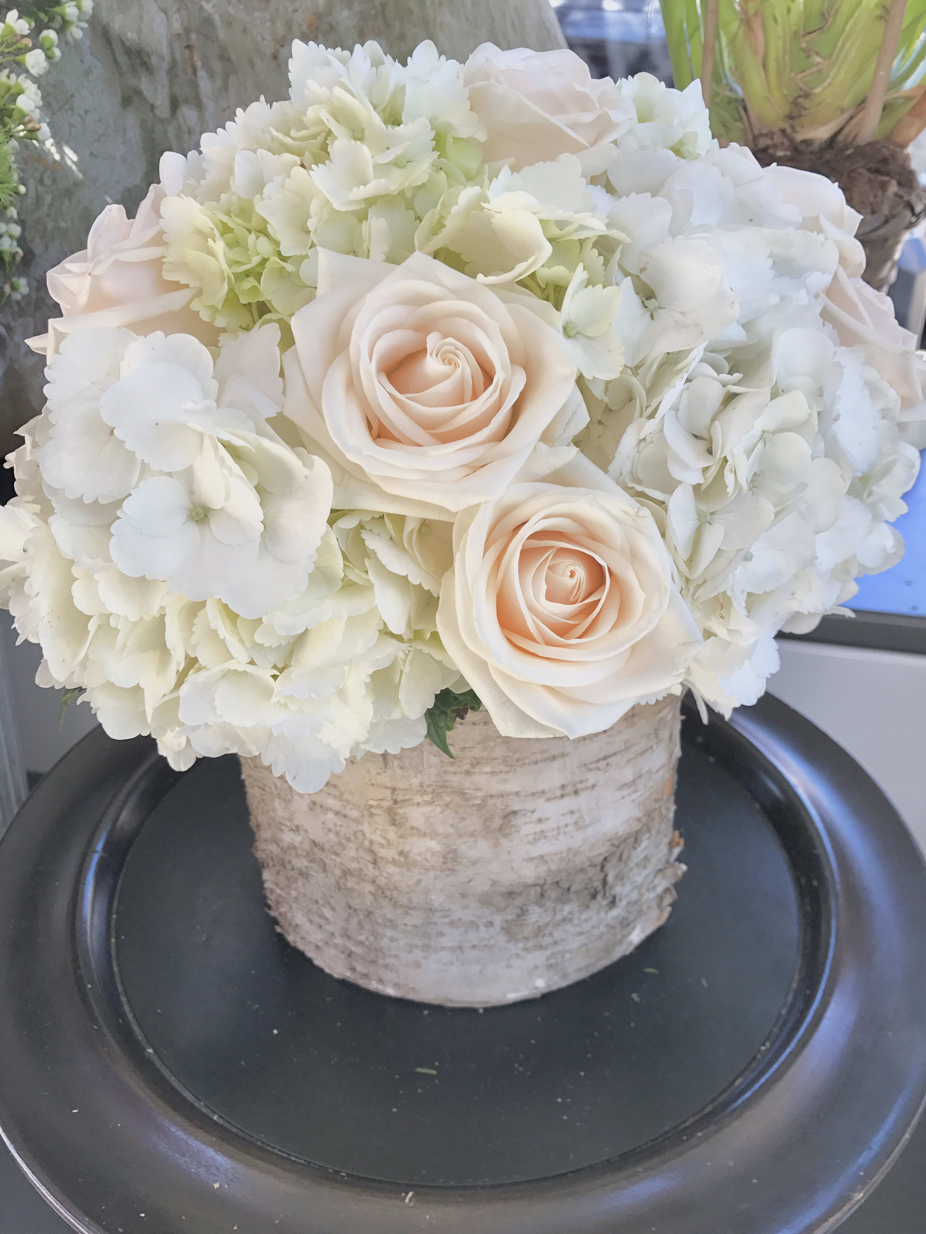 Simplicity  - White hydrangeas and ivory roses in a beautiful birch bark vase.