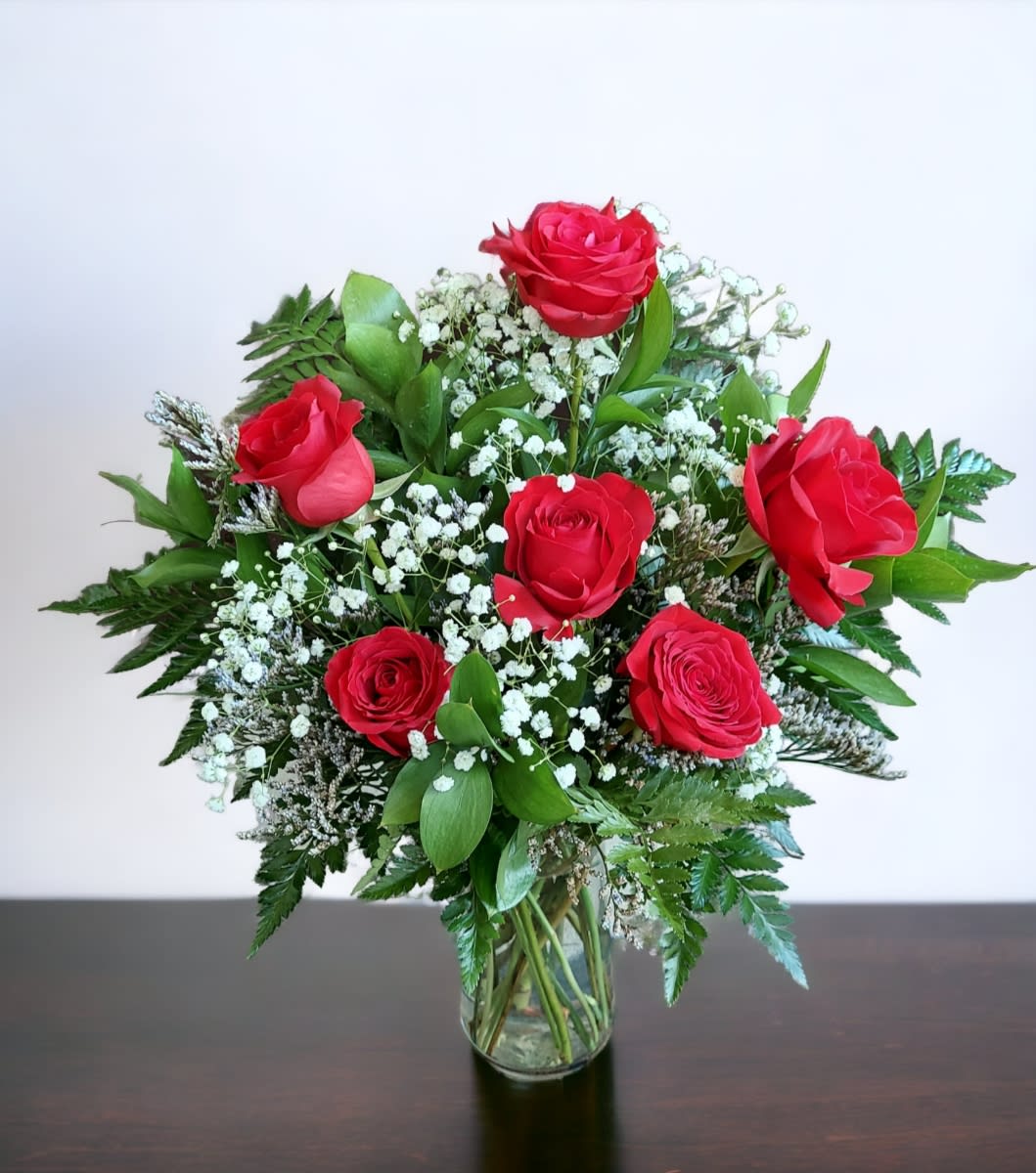 Ruby Radiance Bouquet - A beautiful bouquet of premium red roses and lush greens, presented in a keepsake vase.  The Ruby Radiance Bouquet is a perfect way to celebrate the love you have for your special someone. Six red roses are paired with baby's breath and lush greens for an elegant effect. This bouquet is presented in a keepsake vase that can be used to display the flowers or even as a beautiful home decor item after the flowers have been enjoyed!  Approximately: 15&quot; W x 16&quot; H 