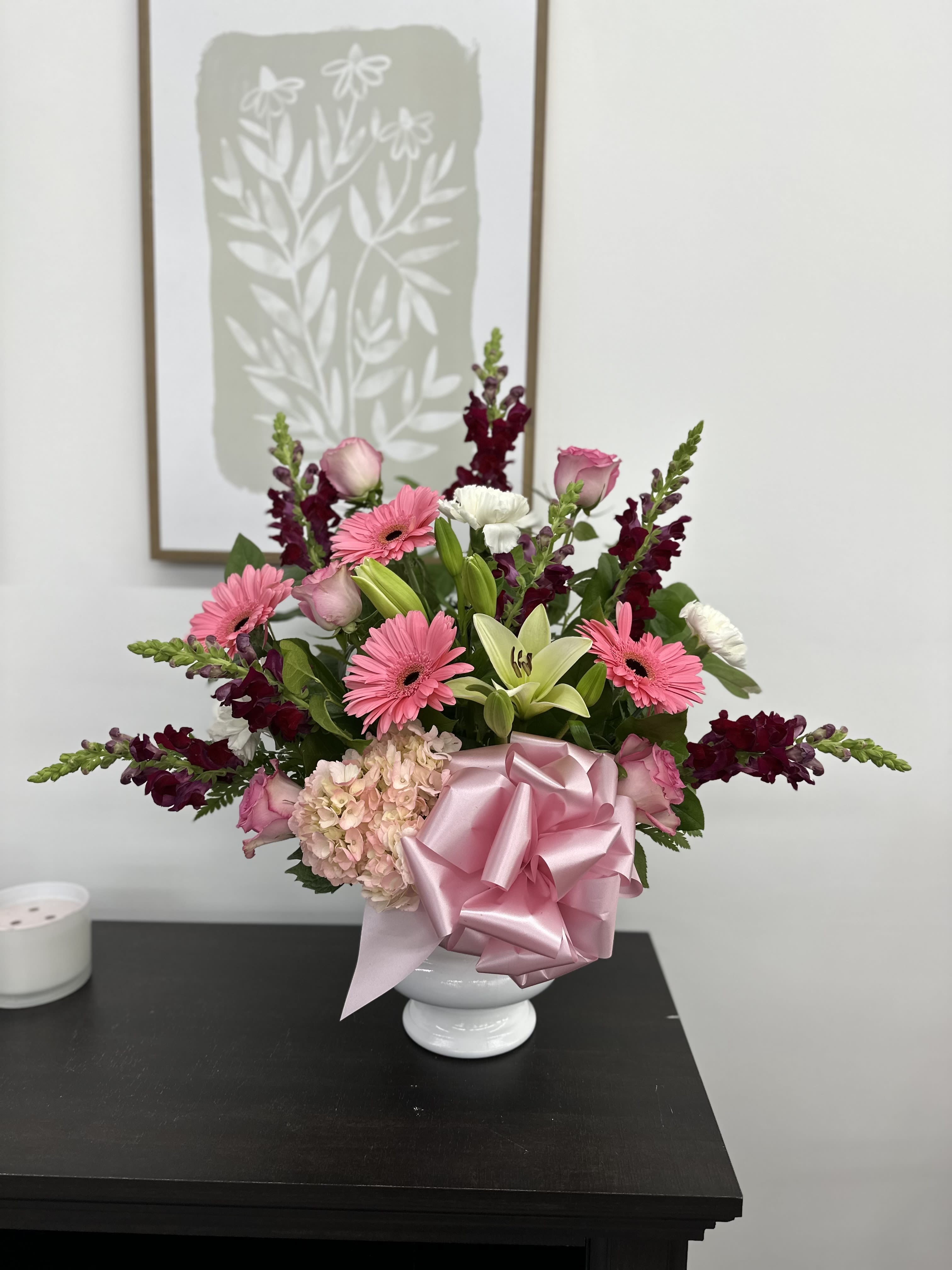 Pretty In Pink - Brighten a special someone's day with this beautiful arrangement of assorted pink and white flowers accompanied with stunning burgundy snapdragons that add the perfect dimension to this piece. 
