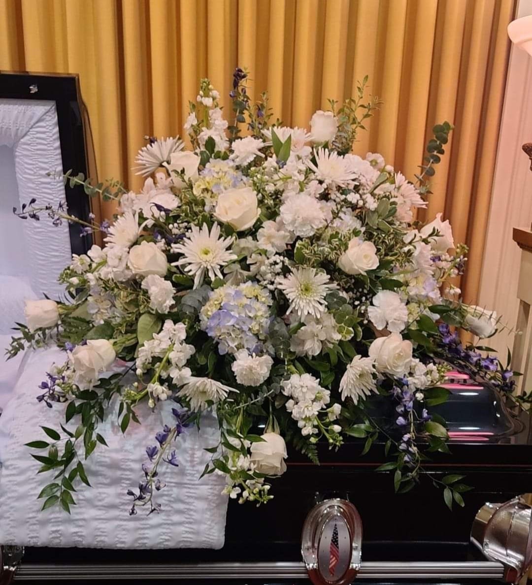 Casket Spray Casket Spray - This Blue and White casket spray, is designed with Delphinium, hydrangeas, roses, carnations stock and assorted greenery. Ribbon endearments may b added upon request.