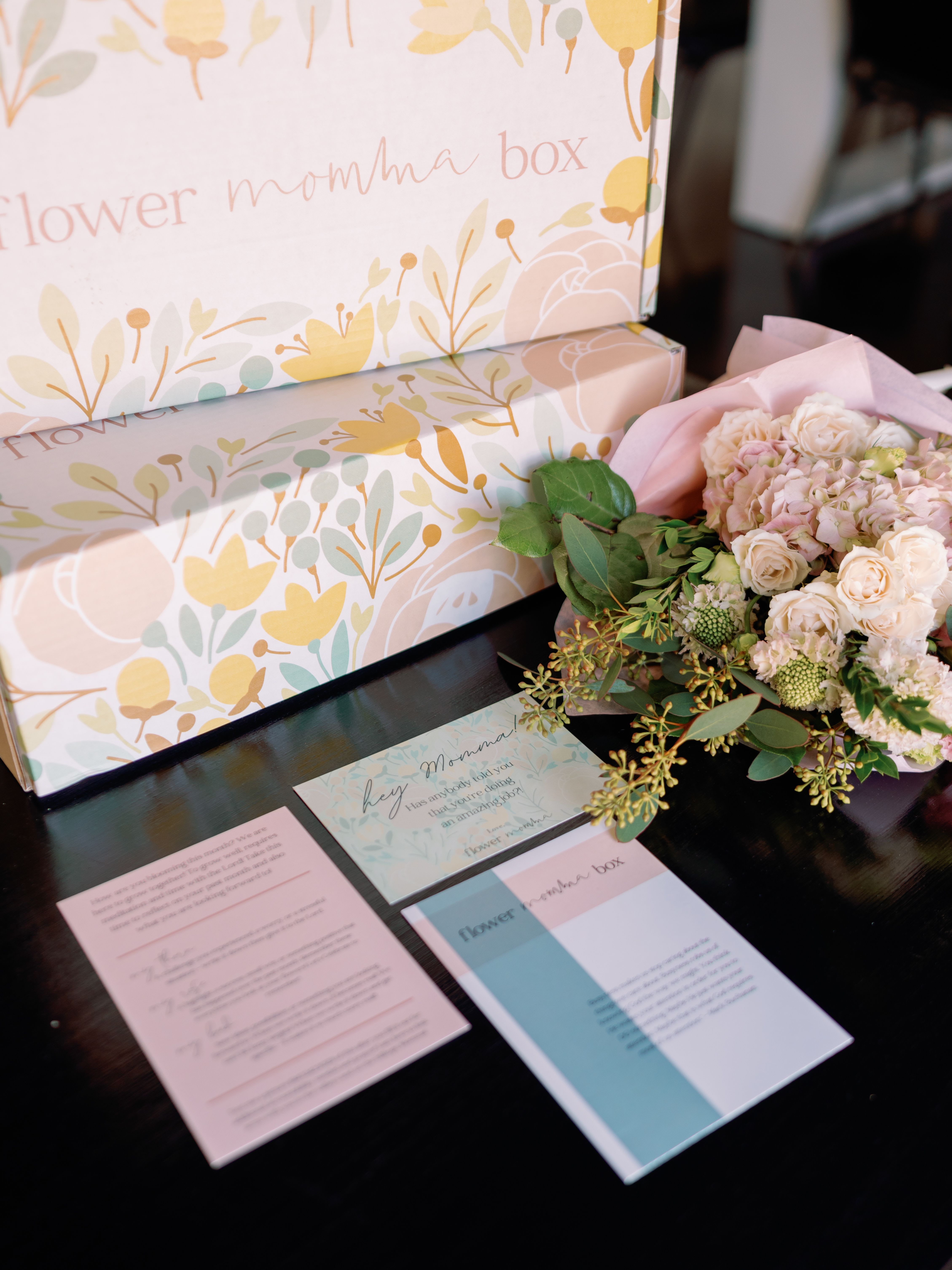 Flower Momma Box - 12 Month Gift Subscription - 2 MONTHS FREE - The Perfect Christmas Gift (or any gift for that matter!) Gift someone you love 6 months to The Flower Momma Box! 2 months free included!   The Flower Momma Community is about creating Rhythms of Celebration and Experiences for women because we believe The Heartbeat of the Bible is Celebration. This is our tangible way to celebrate in your home each month!  What comes in the box?  A Wrapped Bouquet of flowers - always a surprise and what is in season! A devotional written by Jenny Lee Hines or a guest from The Flower Momma Podcast Self Reflection Rose/Bud/Thorn insert - What was good and hard?Where are you hopeful?