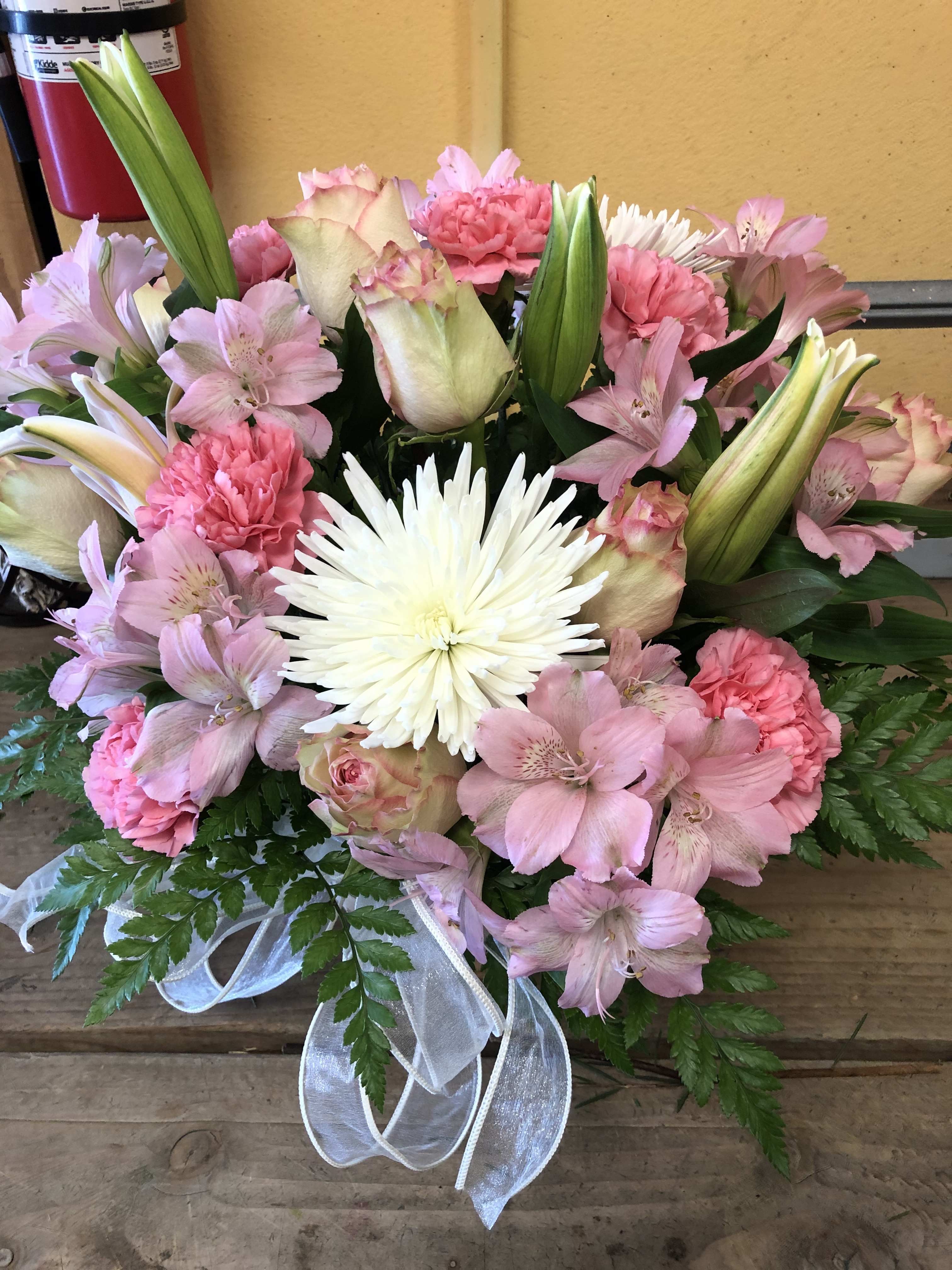MOTHER'S DAY BASKET ARRANGENMENT MOTHER'S DAY BASKET ARRANGENMENT - COLORFUL MIX FLOWER BASKET, IT IS AT LEAST 2 FEET TALL IT INCLUDES 5 ROSES AND 2 LILIES AND OTHER FLOWERS.