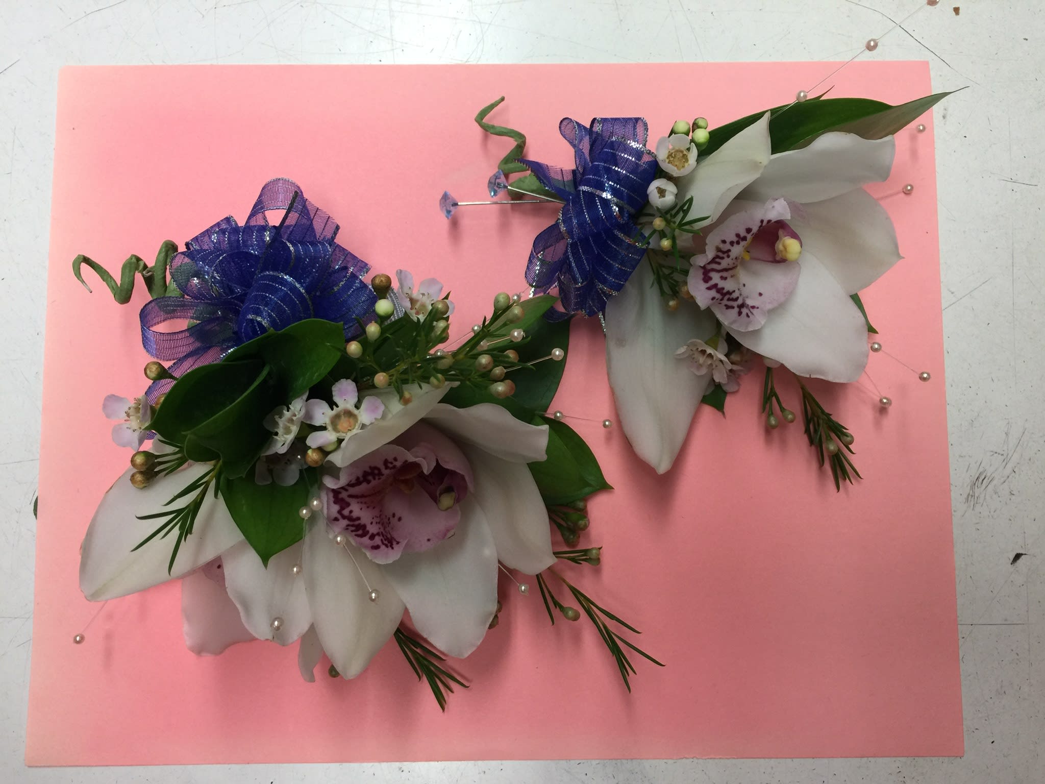Boutonniere with cymbidium orchid Boutonniere with cymbidium orchid - Boutonniere focal with single cymbidium orchid. Please check availability.