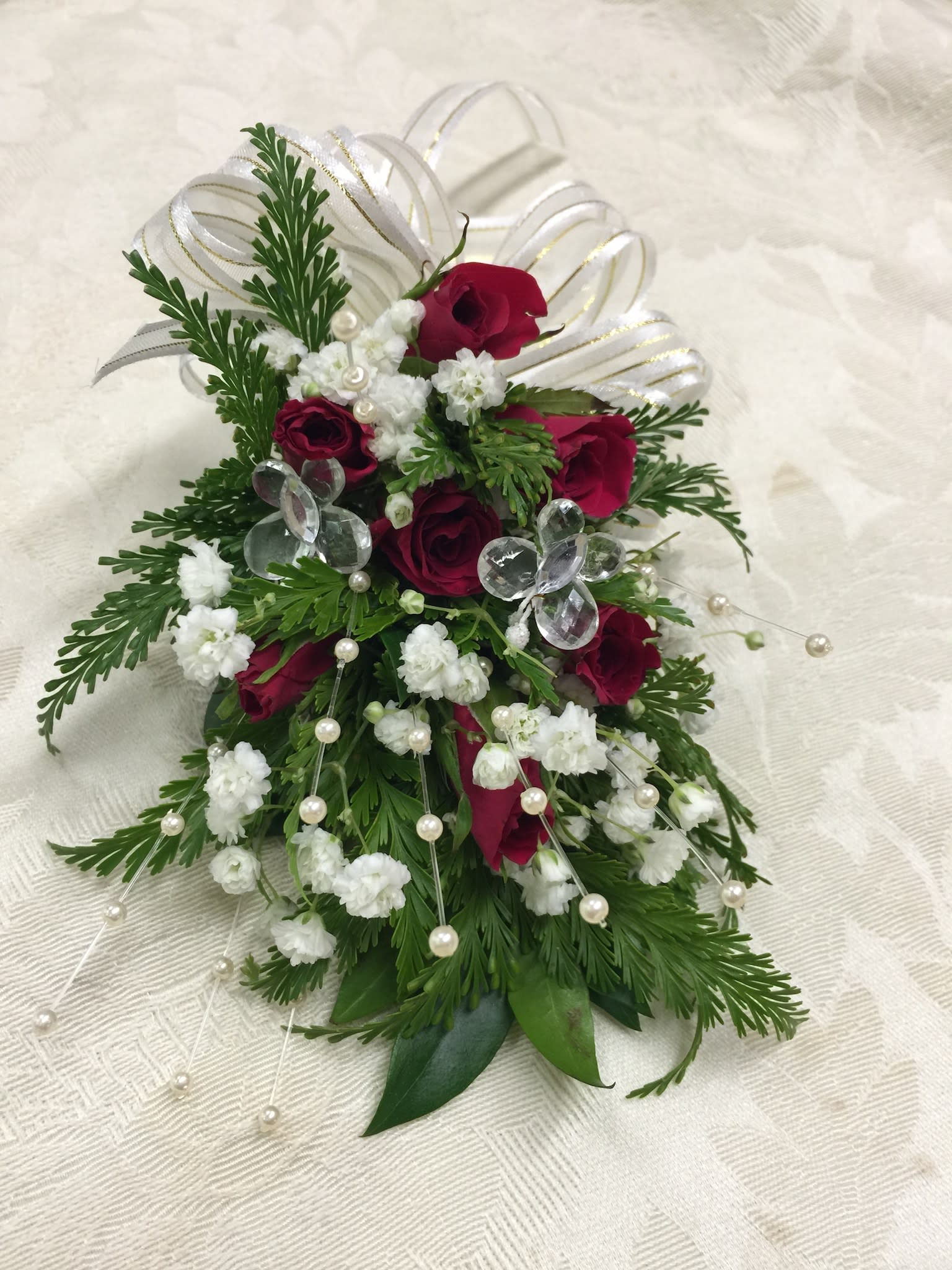 Wrislet with Baby Roses - Hand made wrislet or corsage with baby rose which may change to match theme color. Beads or crystals may also be added to accent the flowers. Please check for availability two day prior. 