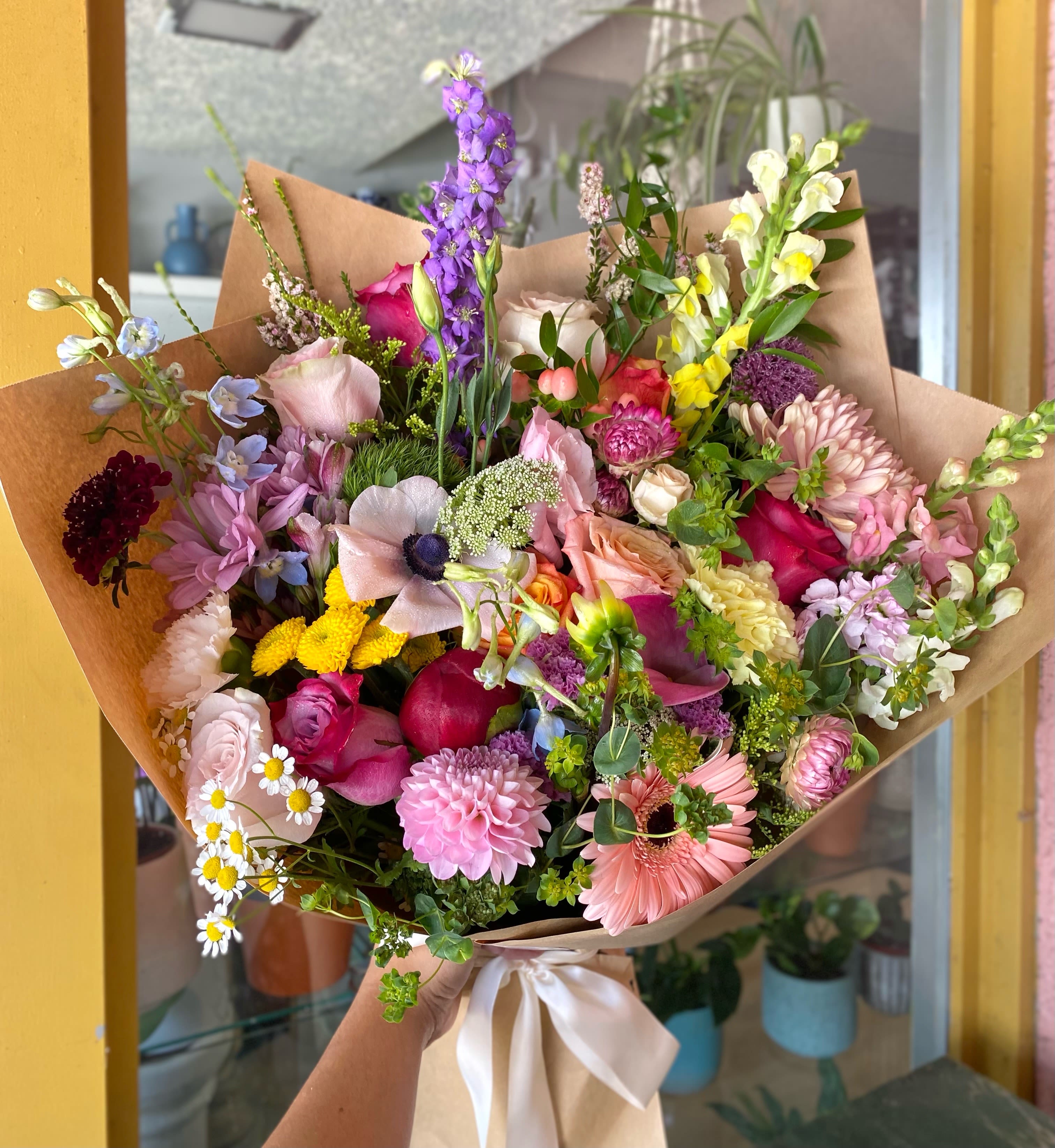 Daydreamer Bouquet  - This stunning bouquet includes a variety of in season flowers, Dahlias, poppies, snapdragons, queen anne, peonies, roses, gerberas, green foliage all beautifully arranged and hand wrapped.