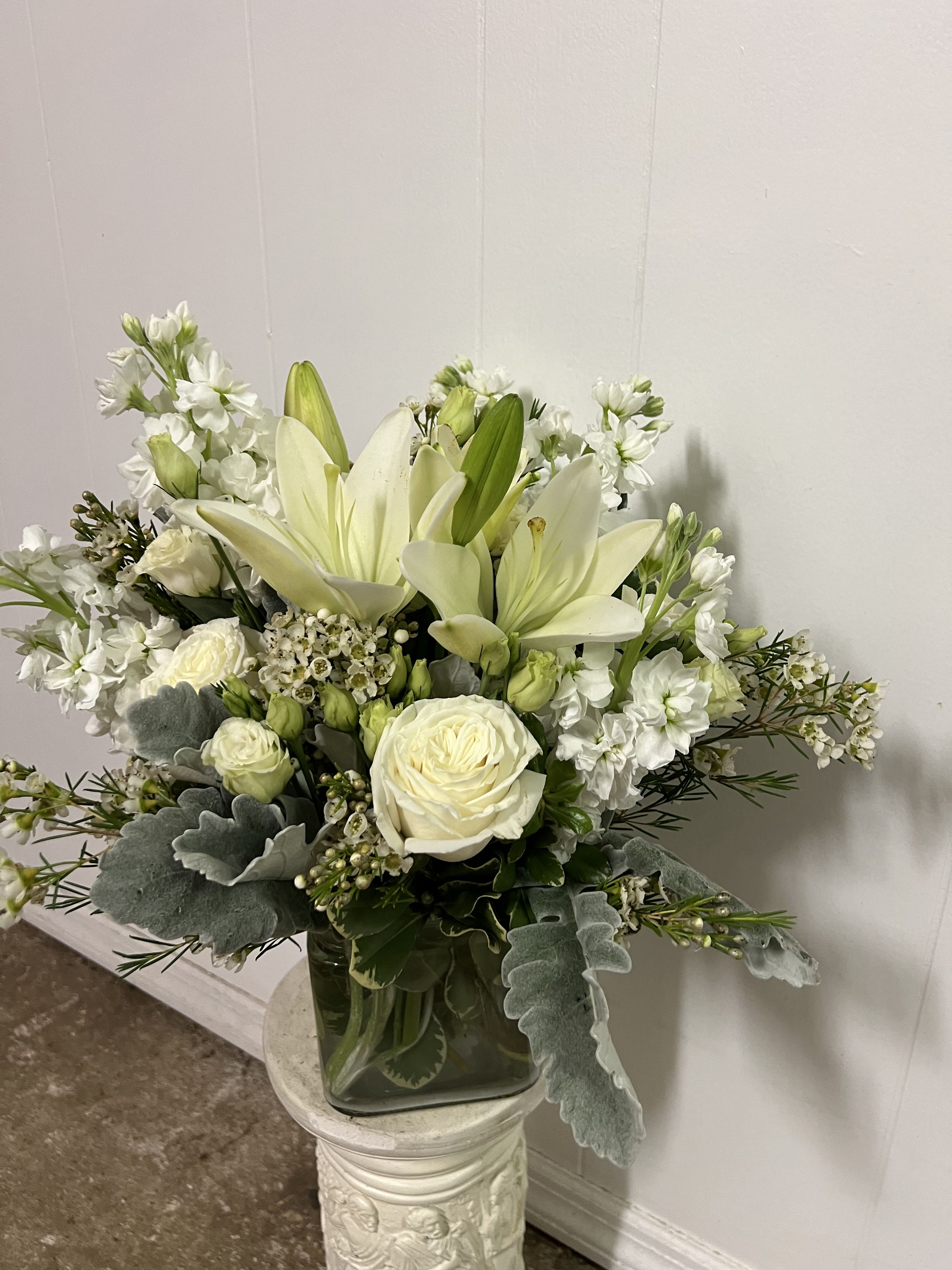 SHIMMERING WHITE SHIMMERING WHITE - WHITE LILIES, ROSES, STOCK, WAX AND DIFFERENT GREENS IN 5" CUBE