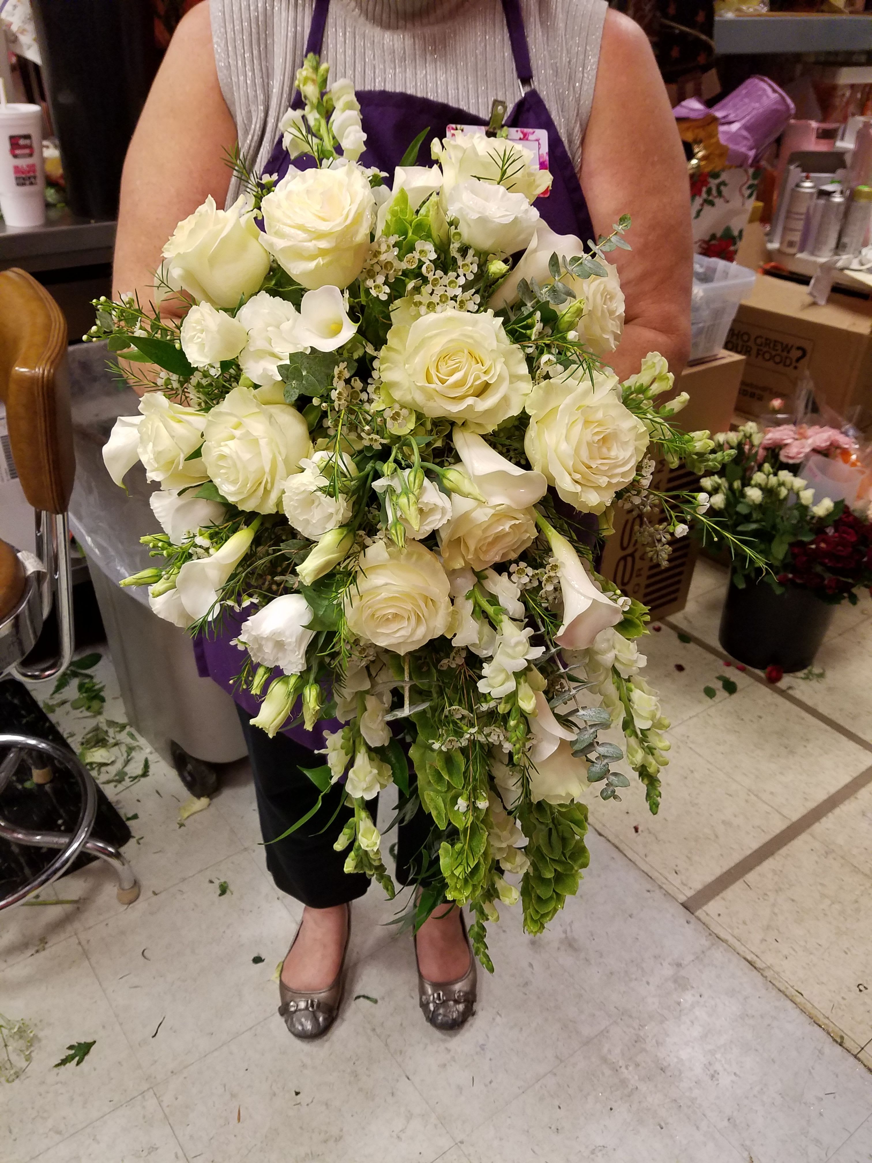 White Bridal Bouquet - This bouquet is designed with white Mondial roses, calla lilies, lisianthus, snapdragons,  belles of Ireland and mixed greens flowers,  with an Irish flair!  