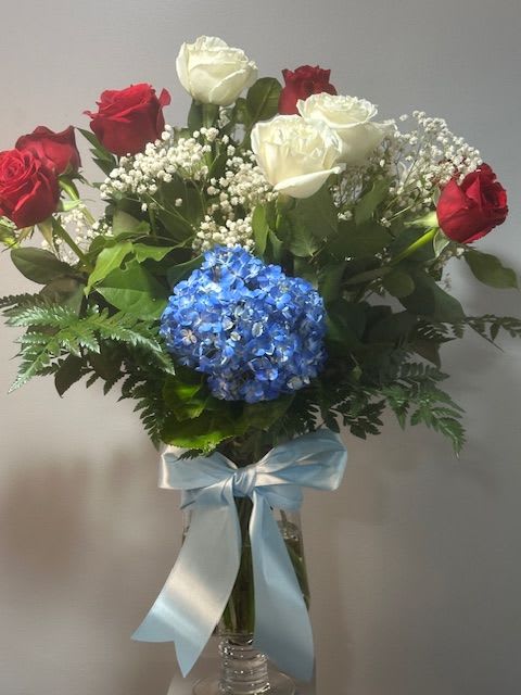 Colorful Tribute by Petals 2 Go Colorful Tribute by Petals 2 Go - This bold bouquet of hydrangea and roses is a versatile tribute on any occasion.