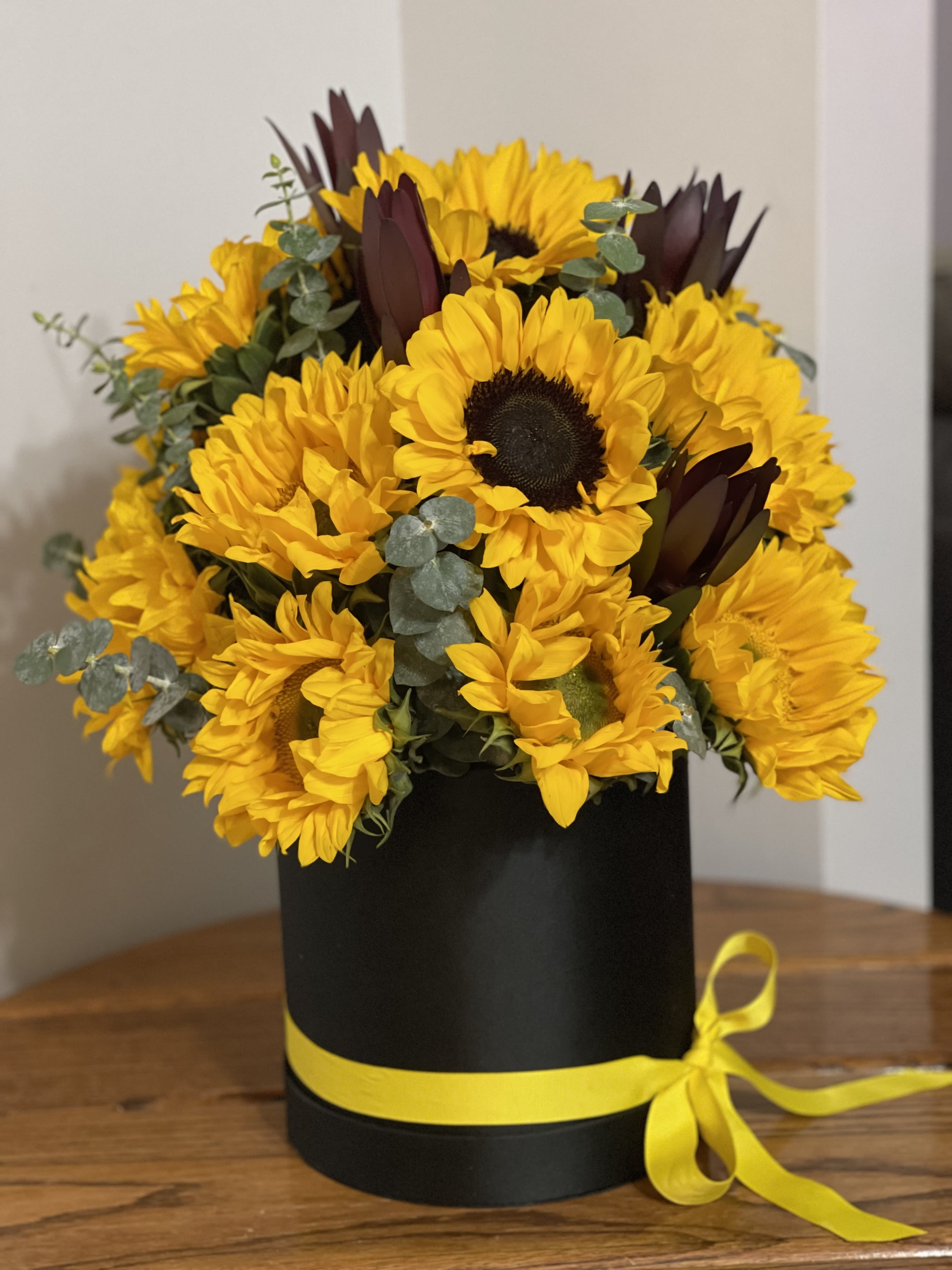 Sunflowers in a Box Sunflowers in a Box - Gorgeous Sunflowers arranged in a box Standard - 15 sunflowers Deluxe - 25 sunflowers, on the photo Premium - 35 sunflowers