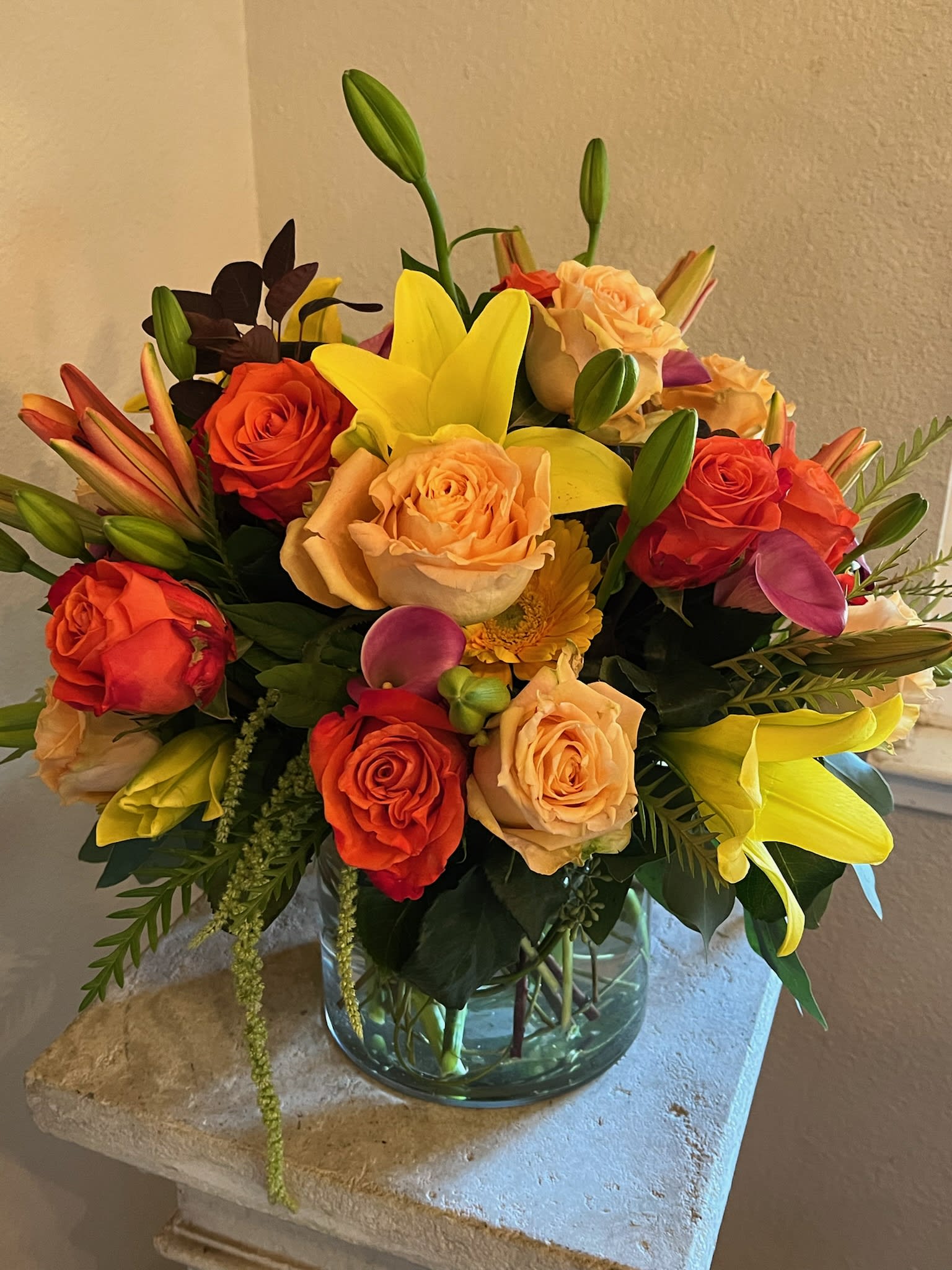 New Fall Blooms - A full and lush selection of fall's best bounty arranged in a clear glass vase. All around design.