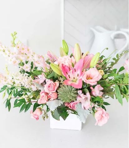  Delicate pastel pinks and a sophisticated Pink Lily - This chic arrangement is the ideal gift for any trendsetter in your life! Delicate pastel pinks and a sophisticated succulent come together in a perfectly harmonious, ultramodern floral display!  Approximate arrangement Height 21&quot;, Length 13&quot;  Includes: • Pink Spray Roses • Pink Lilies • Pink Alstroemeria • Pink Carnations • Pink Lisianthus • Pink Larkspur • White Statice • Echeveria Succulent