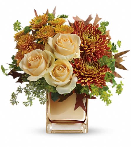 Teleflora's Autumn Romance Bouquet Teleflora's Autumn Romance Bouquet - Your special someone is sure to fall in love with this fabulous fall bouquet featuring lush roses and warm autumn blooms in a sparkling bronze mirrored glass cube. This elegant bouquet features creamy peach roses gold cushion chrysanthemums bronze disbud chrysanthemums bupleurum seeded eucalyptus and oak leaves. Delivered in an exclusive bronze Mirrored Cube vase.Approximately 12 1/2" W x 12 1/2" H Orientation: One-Sided As Shown : TFL05-1ADeluxe : TFL05-1BPremium : TFL05-1C