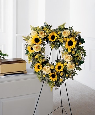 Forever Heart - Sunflower, roses, and carnations are used to create a brilliant expression of love and support. Approximately 28H&quot; X 24W&quot;