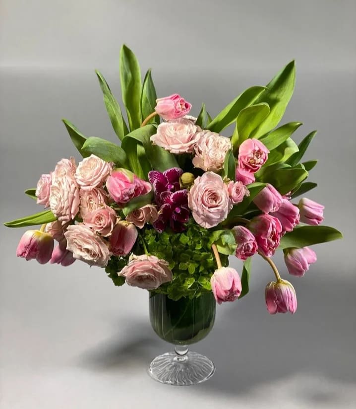 Victorian Pink - A sweet and elegant arrangement that evokes a classic style and made to feel like you grabbed some lovely blossoms on your afternoon stroll through a Victorian garden. Spray roses and tulips are accented with a touch of mini phalaenopsis orchids in a delicate glass vase.