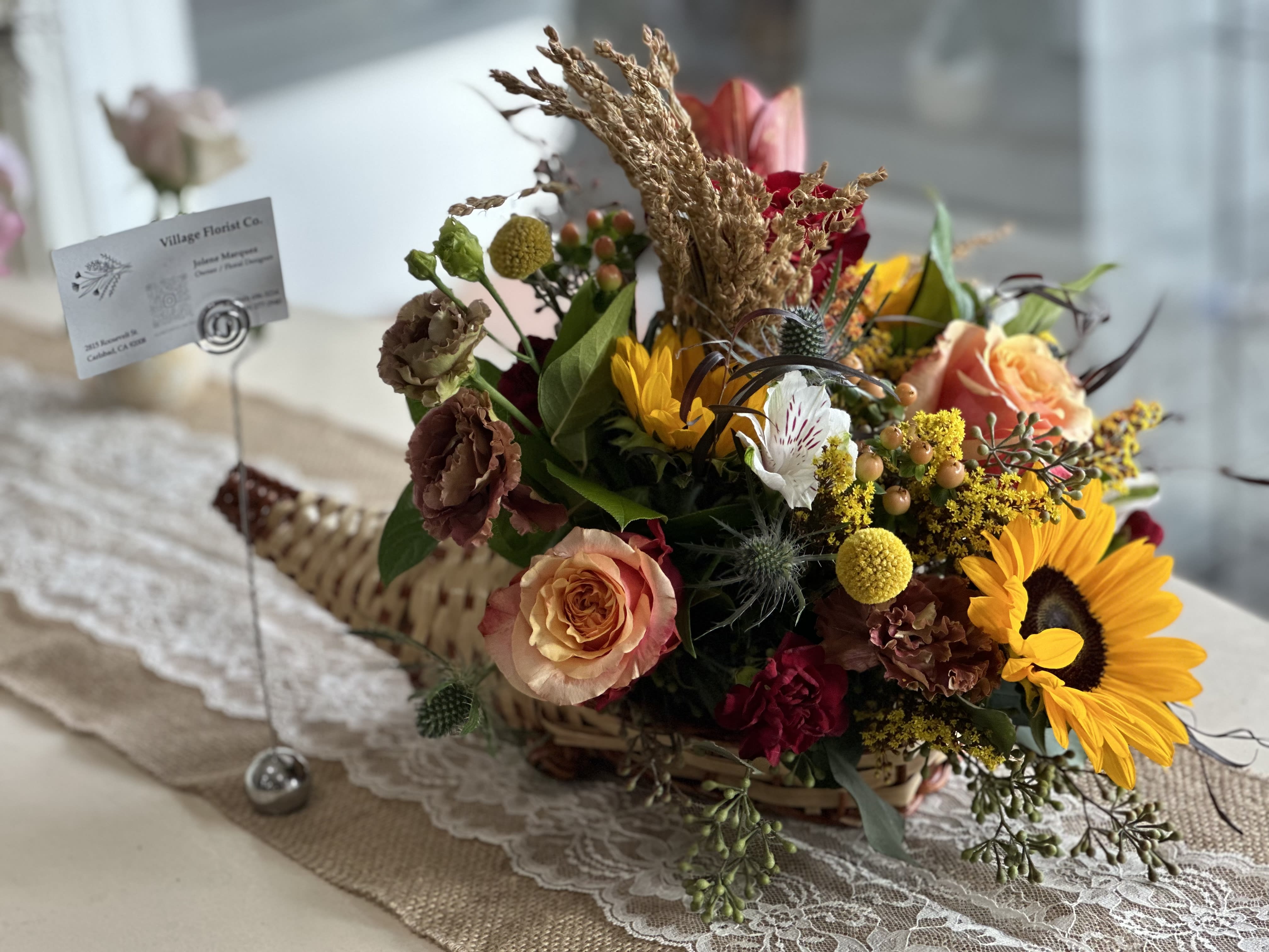 Elegant Autumn Cornucopia  - Elevate your Thanksgiving table this Holiday with our exquisite flower arrangements meticulously curated to capture the rich colors of fall.  Warm tones of burgundy, amber, and deep orange blend seamlessly with vibrant reds and golden yellows that embodies the spirit of the season.   Each arrangement features a beautiful mix of seasonal blooms, complemented by textured foliage and rustic accents. 