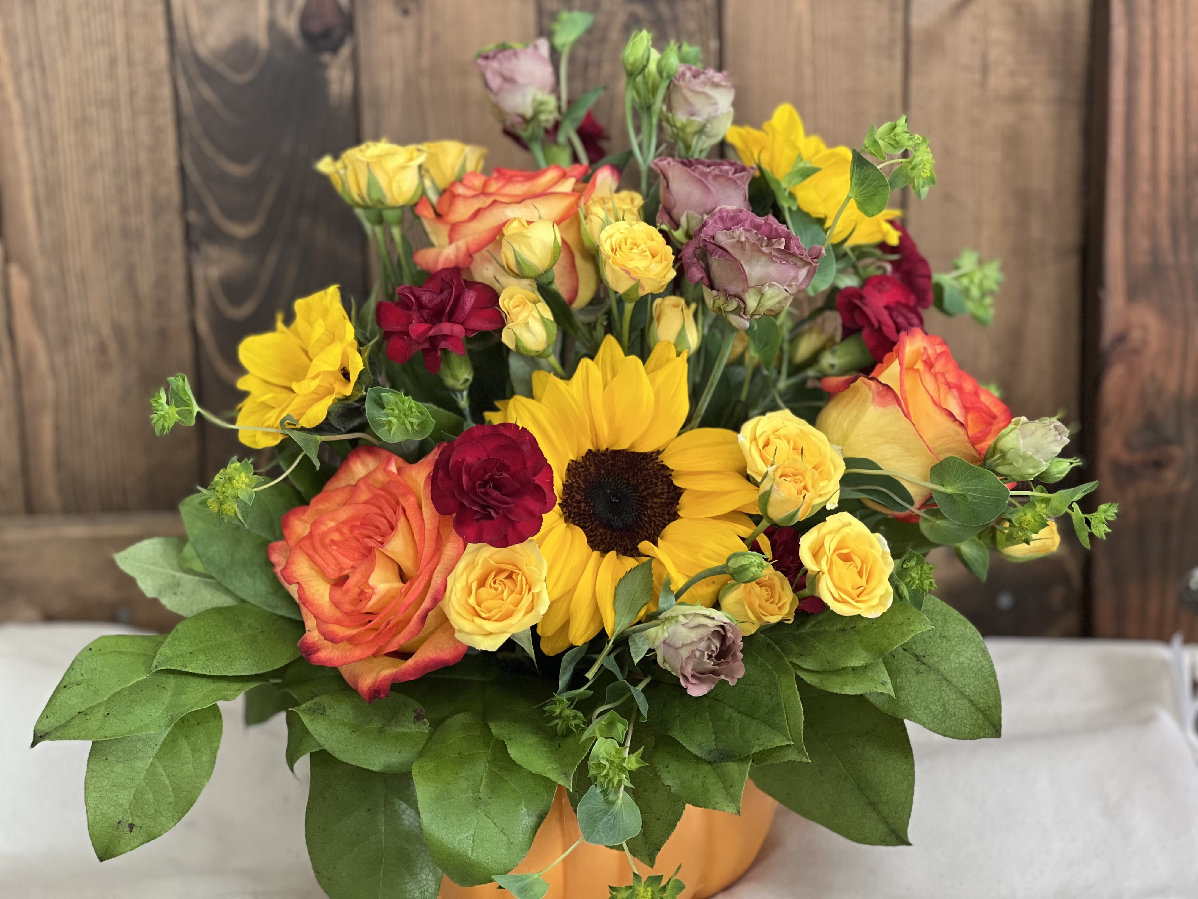 The Great Pumpkin Waltz The Great Pumpkin Waltz - This unique arrangement showcases vibrant seasnal blooms artfully arranged in a ceramic pumpkin, creating a festive centerpiece that embodies the spirit of autumn.
