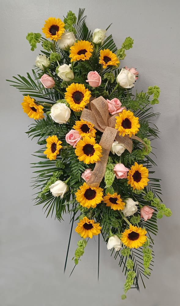 Country Garden Standing Spray Country Garden Standing Spray - Standing sympathy spray with country garden charm. Spray includes sunflowers, peach roses, green carnations, and bells of Ireland.
