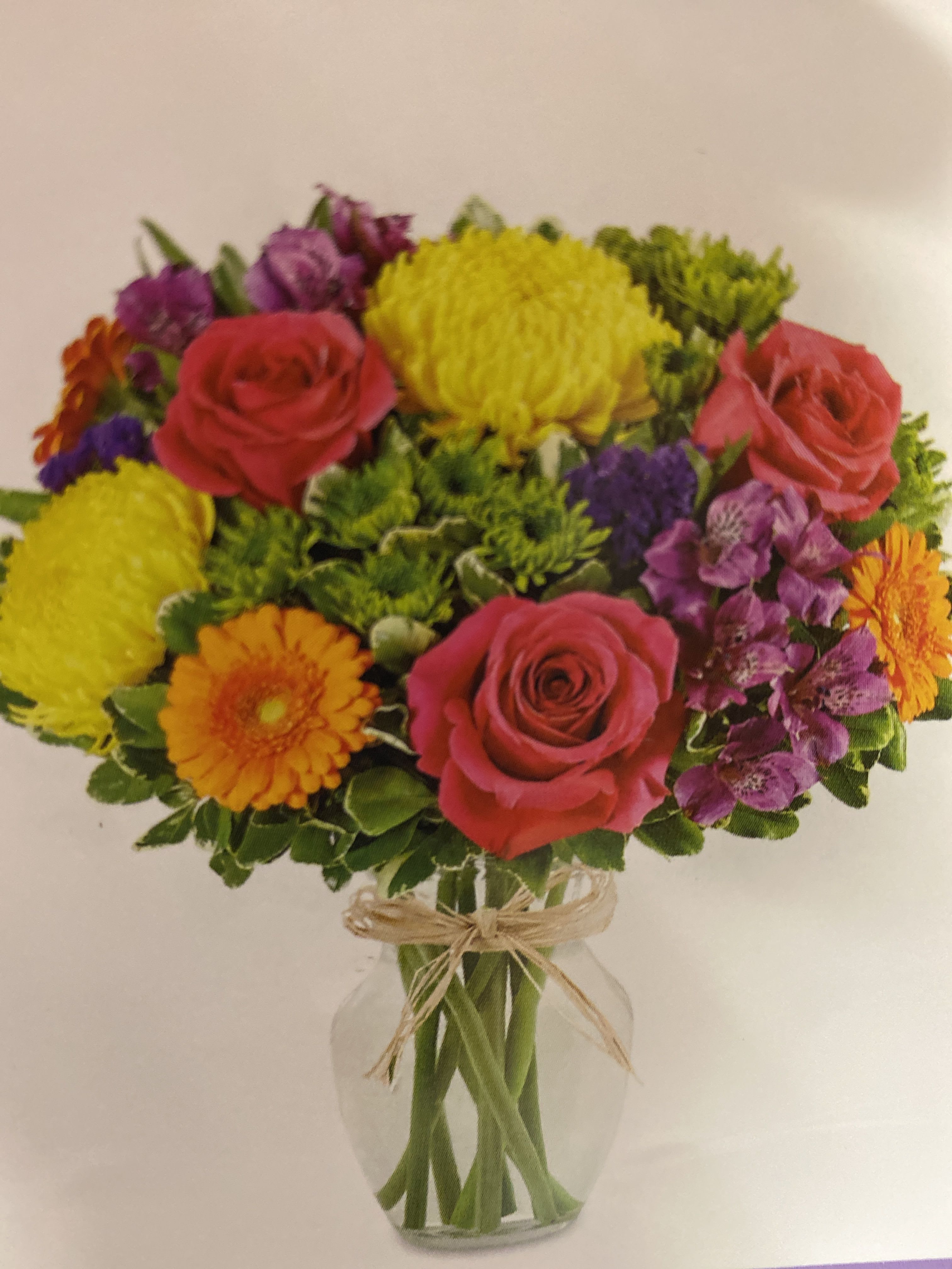 Vibrant floral medley celebration Vibrant floral medley celebration - Hot pink roses, mini orange, Gerbers, yellow, crones, green buttons, purple alstroemerias Purple status greenery