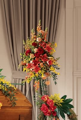 Farewell Too Soon Standing Spray Farewell Too Soon Standing Spray - A lovely sentiment at a difficult time. This spray stars lilies and red roses surrounded by yellow oncidium orchids, snapdragons spray roses, and more. Delivered on an easel and appropriate to send to a funeral. Approximately 30H" X 19W"