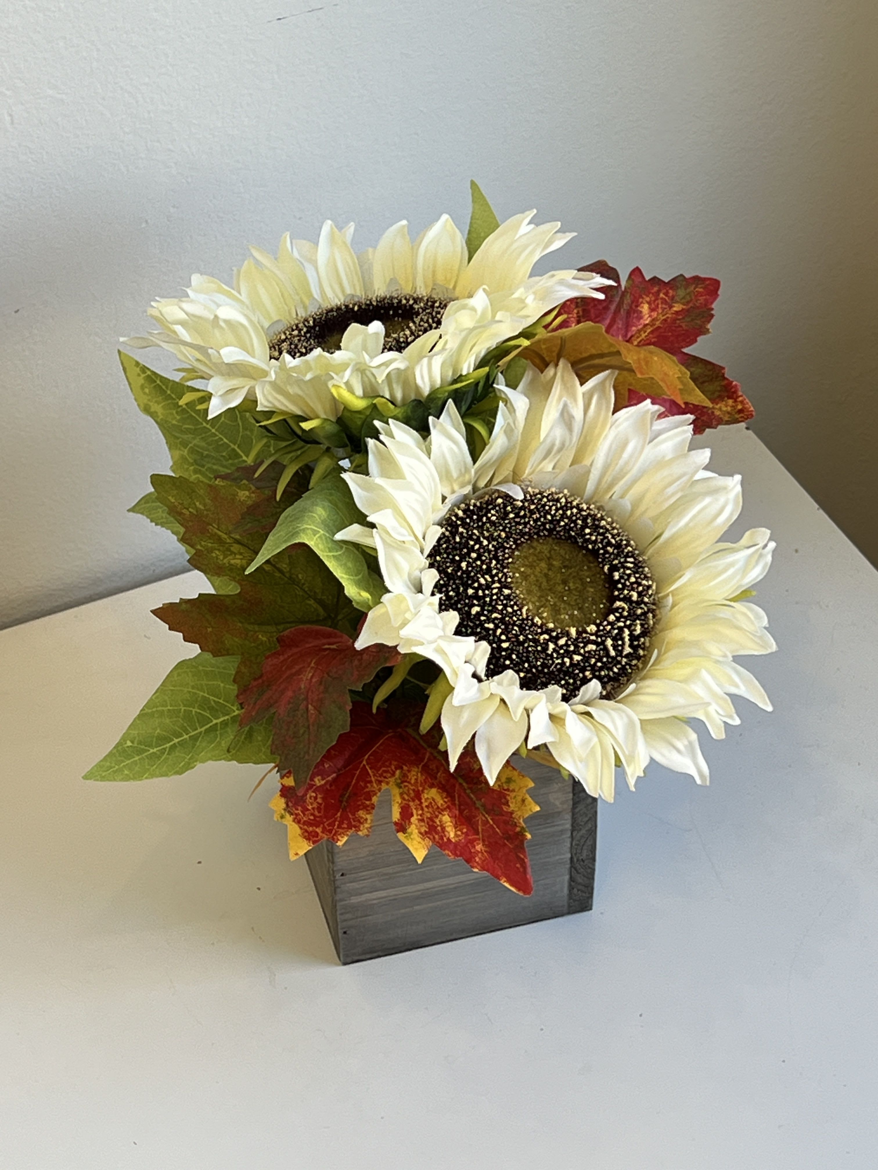 FAUXFL-2 - A Permanent Flower Arrangement That Can Be Enjoyed For Many Years.  White Sunflowers and Fall Leaves Designed in a Square Wood Box.