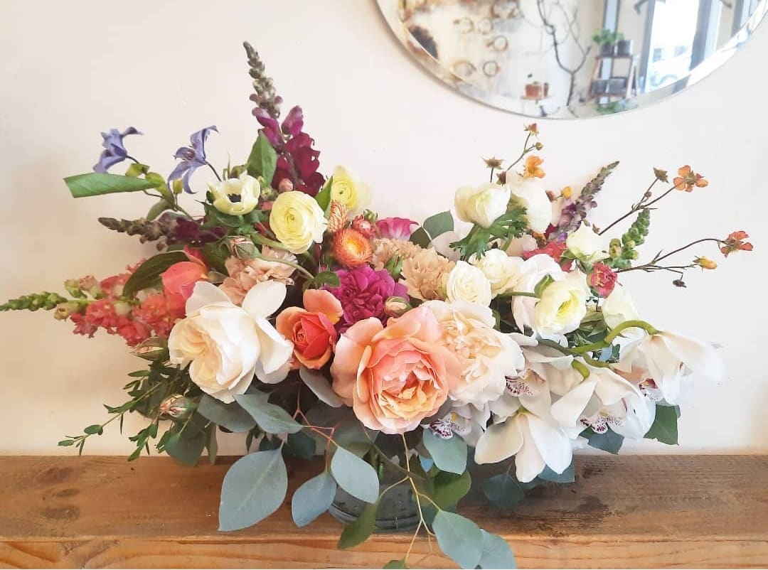 Designers choice pastel color palette - Designers choice arrangement using fresh seasonal hand picked market flowers. Flower type and color will vary depending on availability. Pastel color palette with bright accent