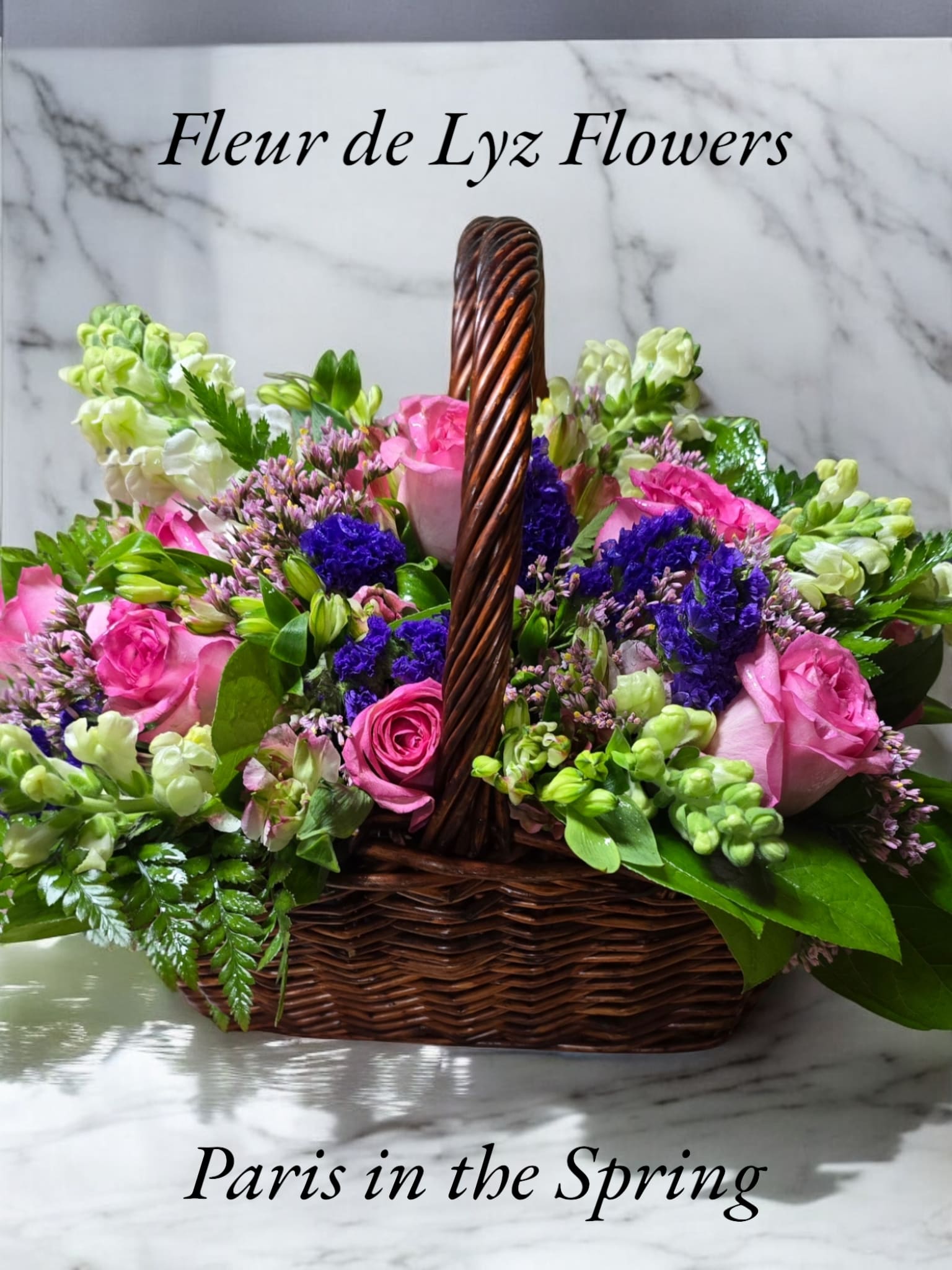 Paris in the Spring - A lovely basket bouquet which includes pin roses and whiesnap dragons.