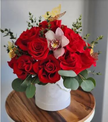 Charme Rose Box - Indulge in the elegance of our &quot;Charme&quot; arrangement. This premium selection features the beauty of roses presented in a stylish box, making it a perfect expression of your deepest emotions. Included in this arrangement: - Standard: 18 roses; with Orchids and Butterflies- Deluxe: 24 roses, with Orchids and Butterflies -Premium: 36 roses, with Orchids and Butterflies. ANY COLOR ROSE. 