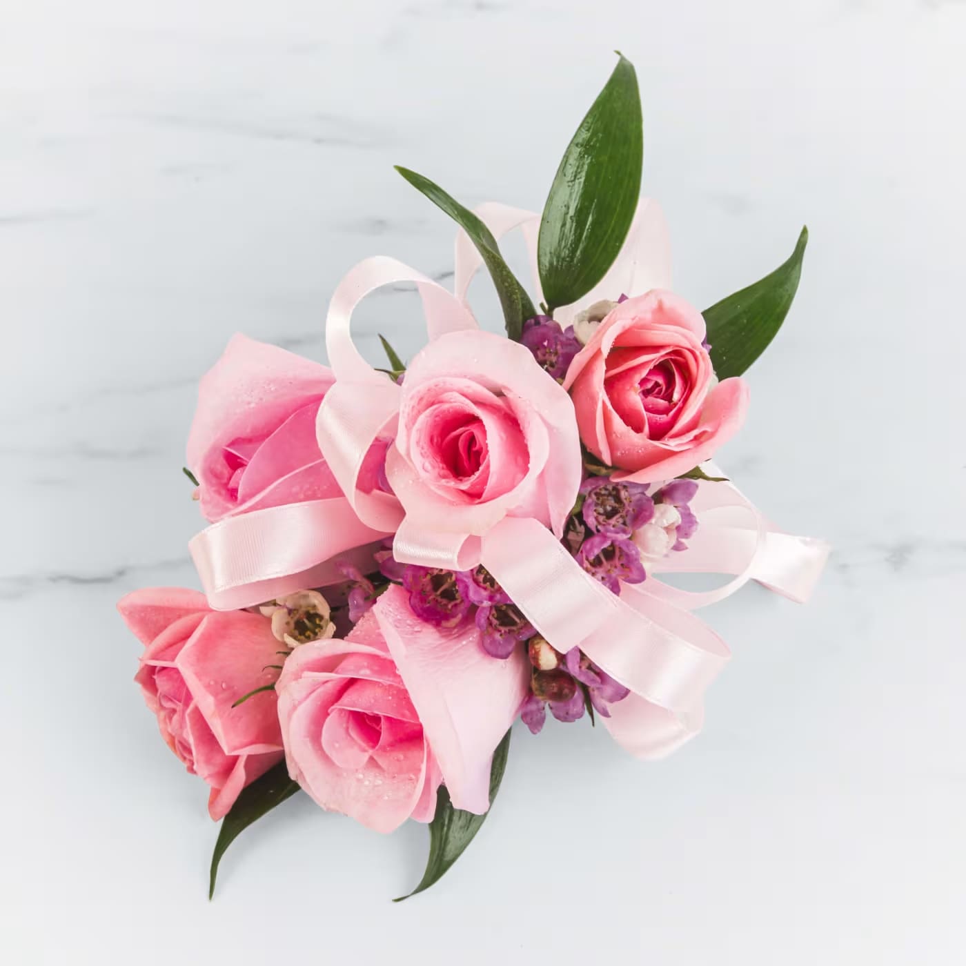 Pink Rose Corsage Pink Rose Corsage - A classic pink corsage hand-tied in pink satin that compliments any outfit. A beautiful addition to any prom, formal, or wedding event.