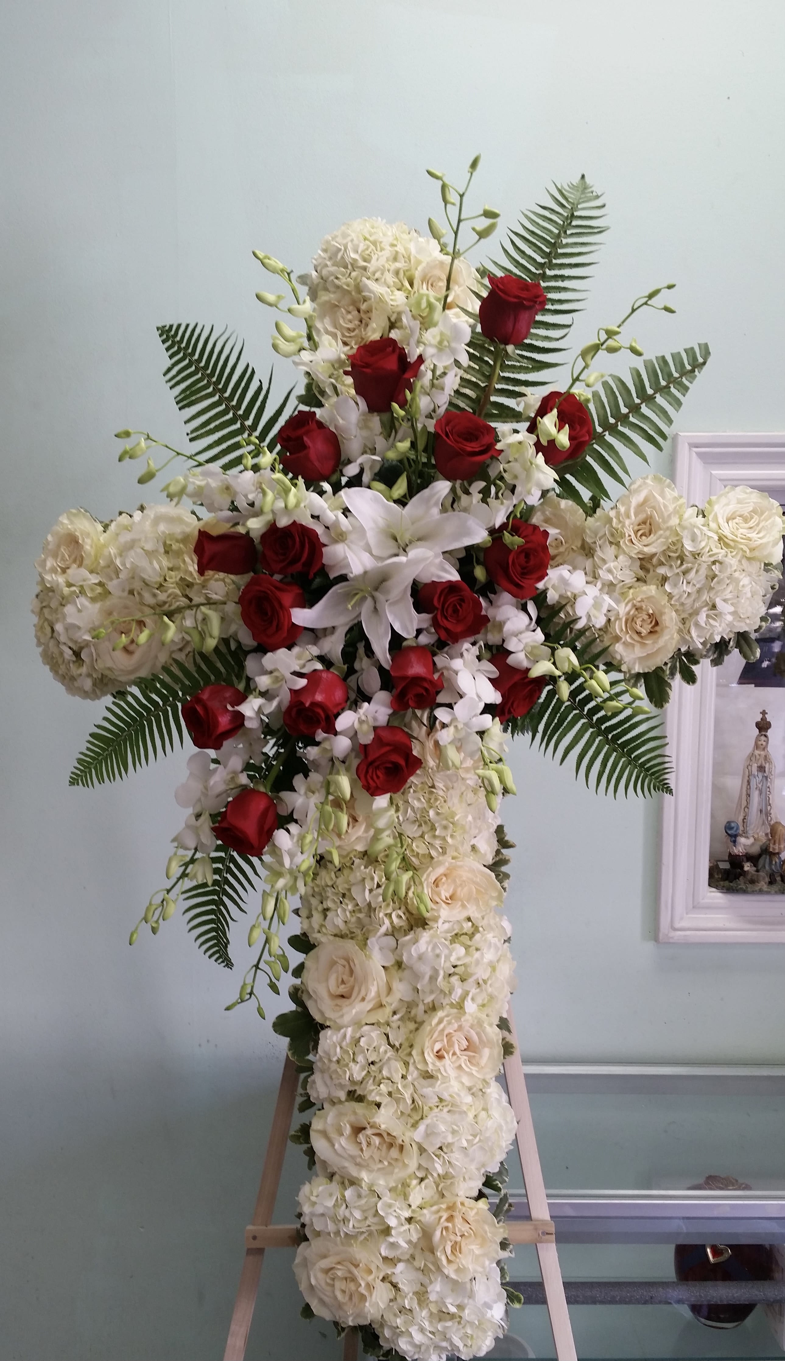Peaceful Devotion Cross Peaceful Devotion Cross - Cross with white hydrangeas, white roses, white lilies, red roses, and white orchids.
