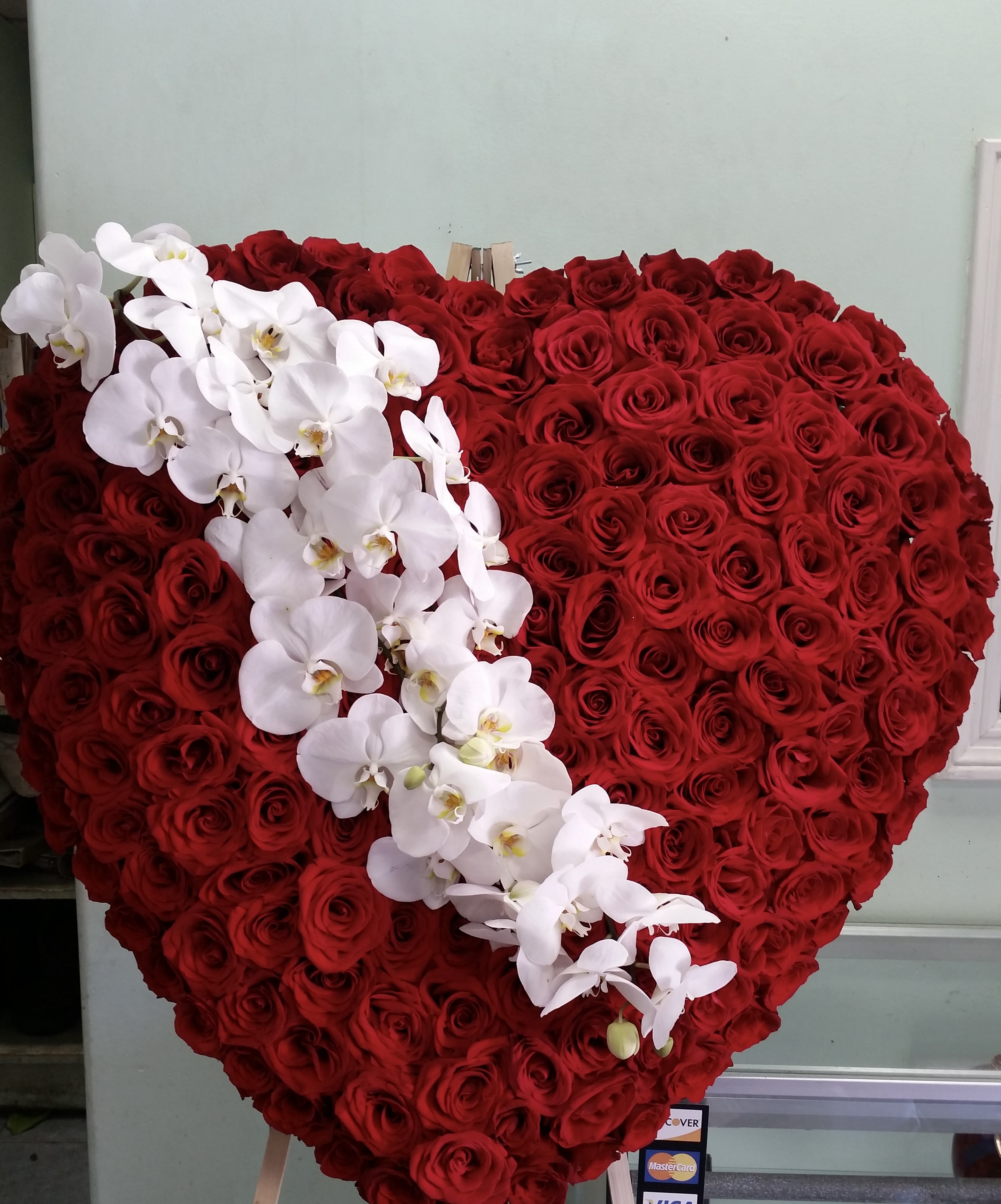 Broken Heart Broken Heart - Heart covered in red roses and white orchids.