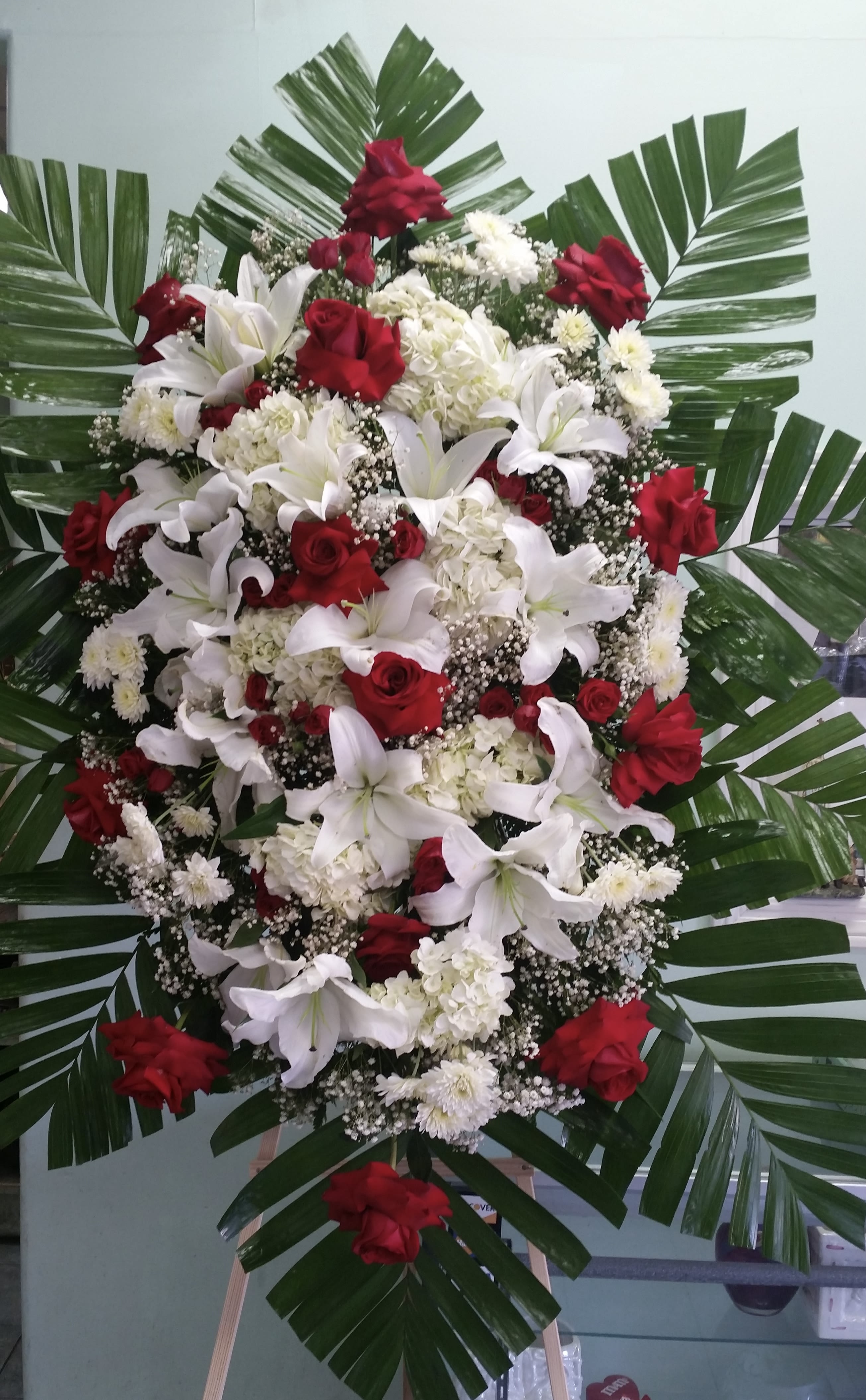 Serenity's Red &amp; White Spray  - Spray with red roses, white lilies, white hydrangeas, and white cushion daises. 