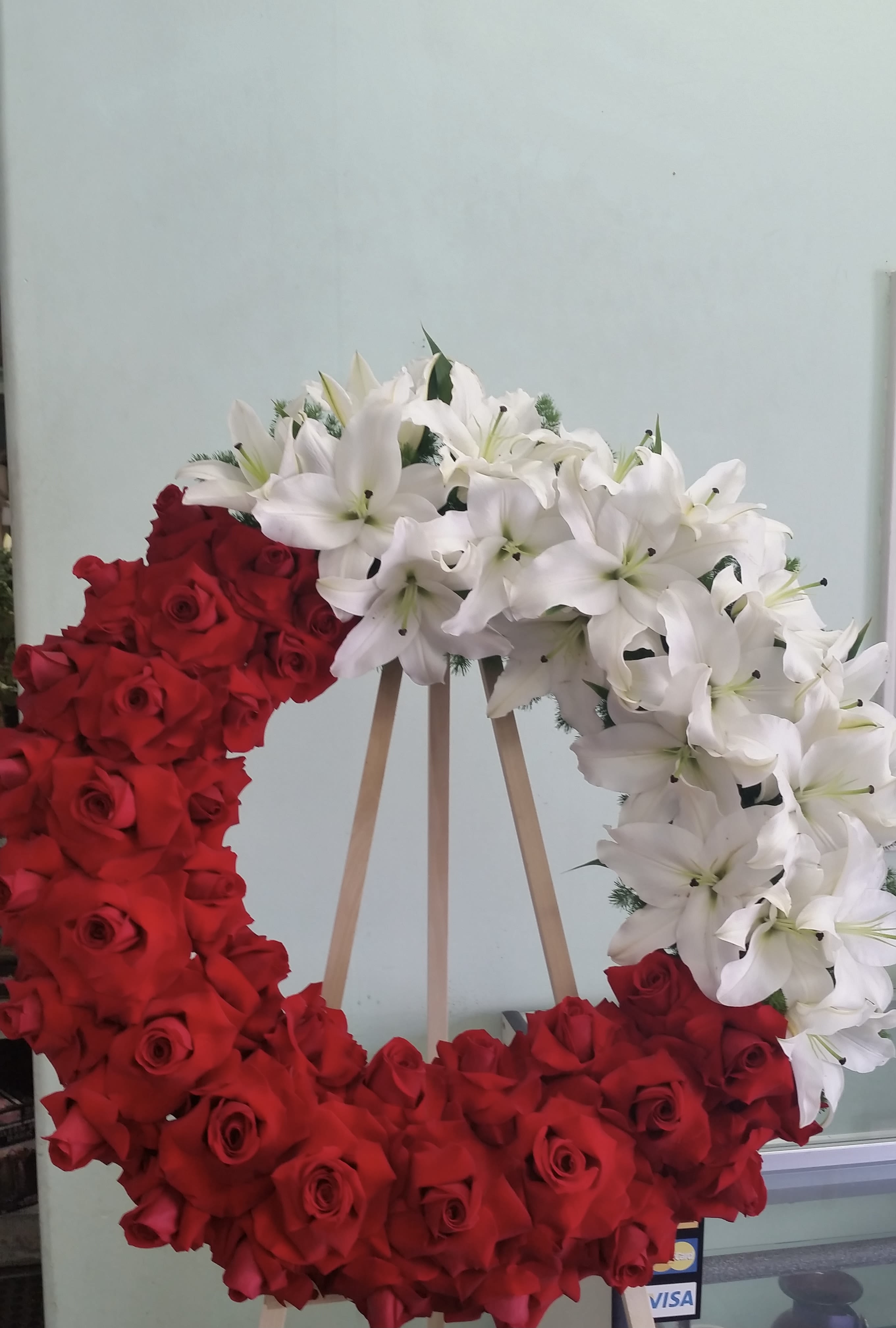 Wreath of Loving Comfort Wreath of Loving Comfort - Open wreath with red roses and white lilies.